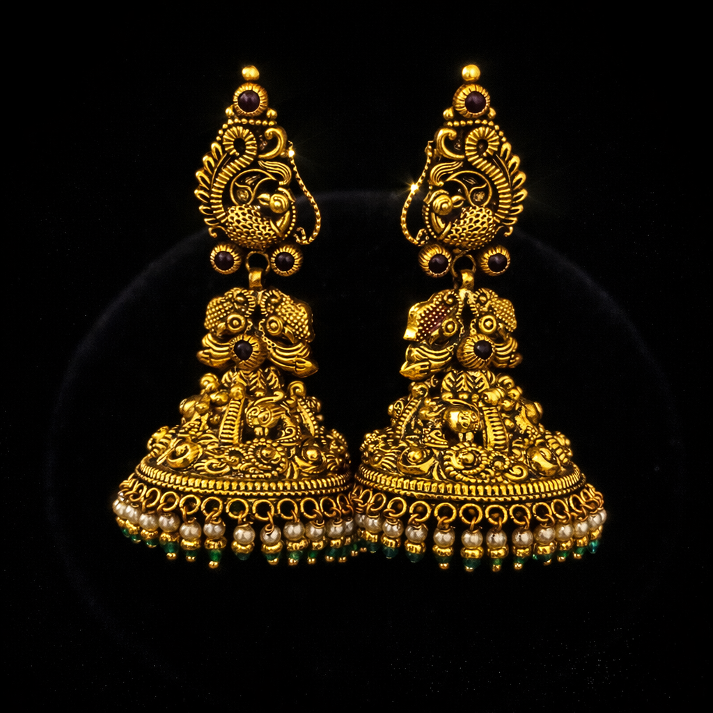 22K Gold Lakshmi Peacock Temple Jhumka earrings with pearl drops, green bead accents, ruby stones and antique finish.
