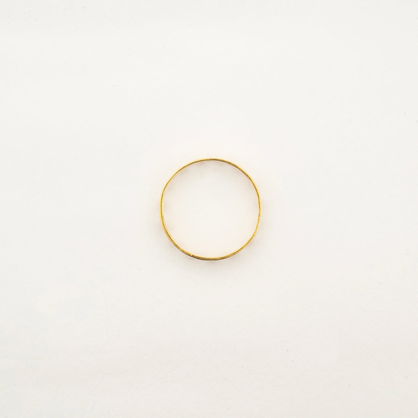 Top view of the handcrafted Sculptyx Caelure 18K gold ring showcasing its refined minimalist silhouette.