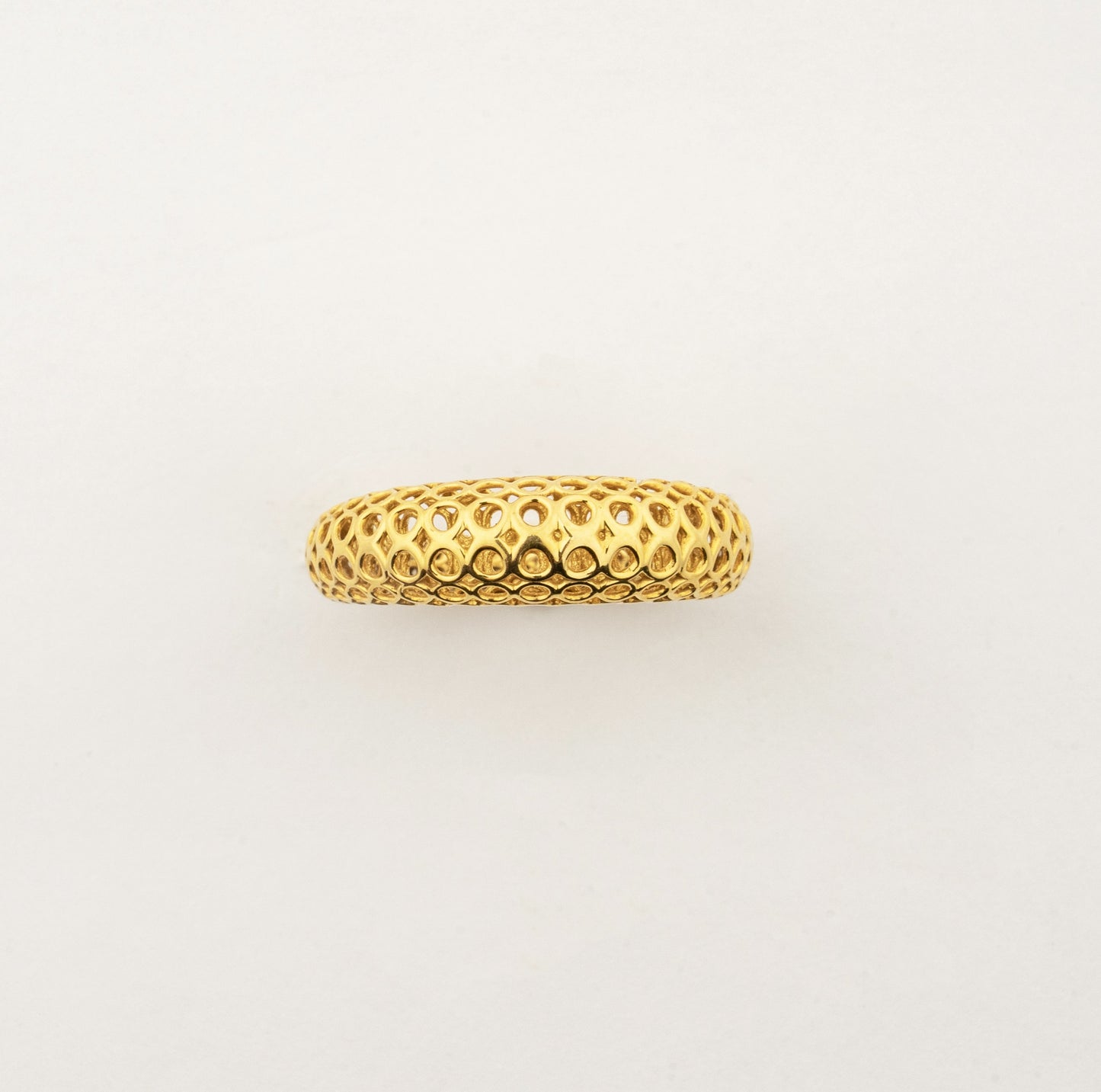 Side profile of the Sculptyx Domaris Solis handcrafted 18K gold textured band ring showcasing its domed silhouette.