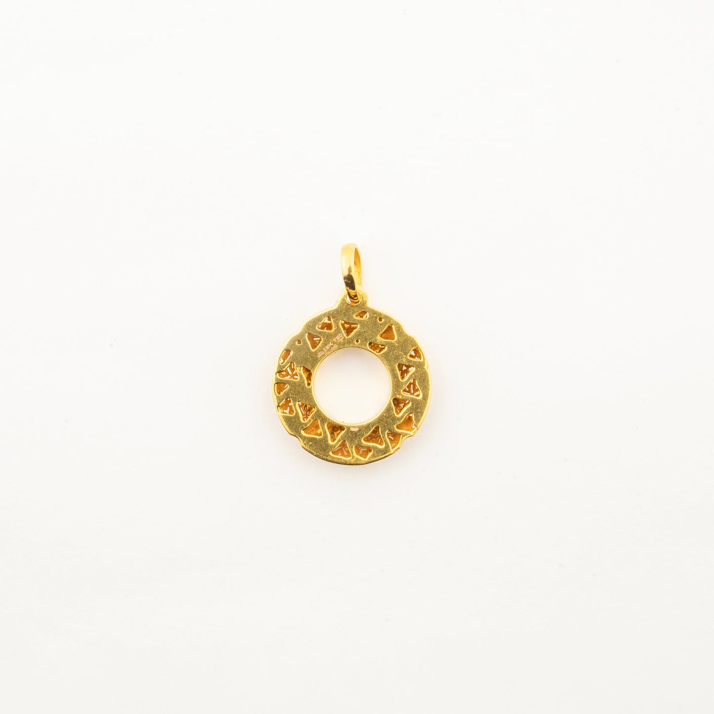 Close-up of the Sculptyx Golden Meridian 18K gold circle pendant highlighting its handcrafted texture and minimalist design.