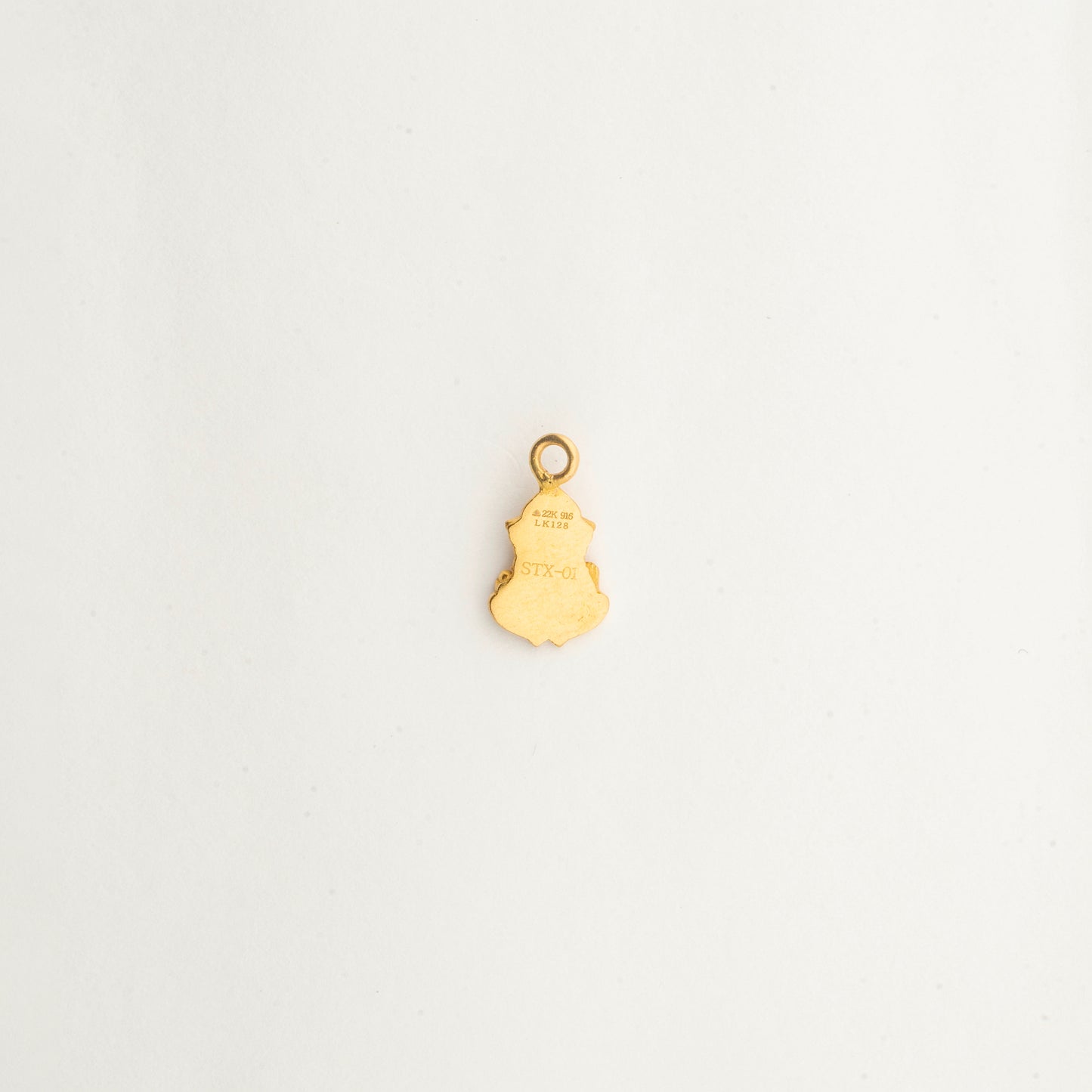 Close-up of the handcrafted 22K gold Lord Ganesha pendant by Sculptyx with intricate sacred detailing and polished finish.
