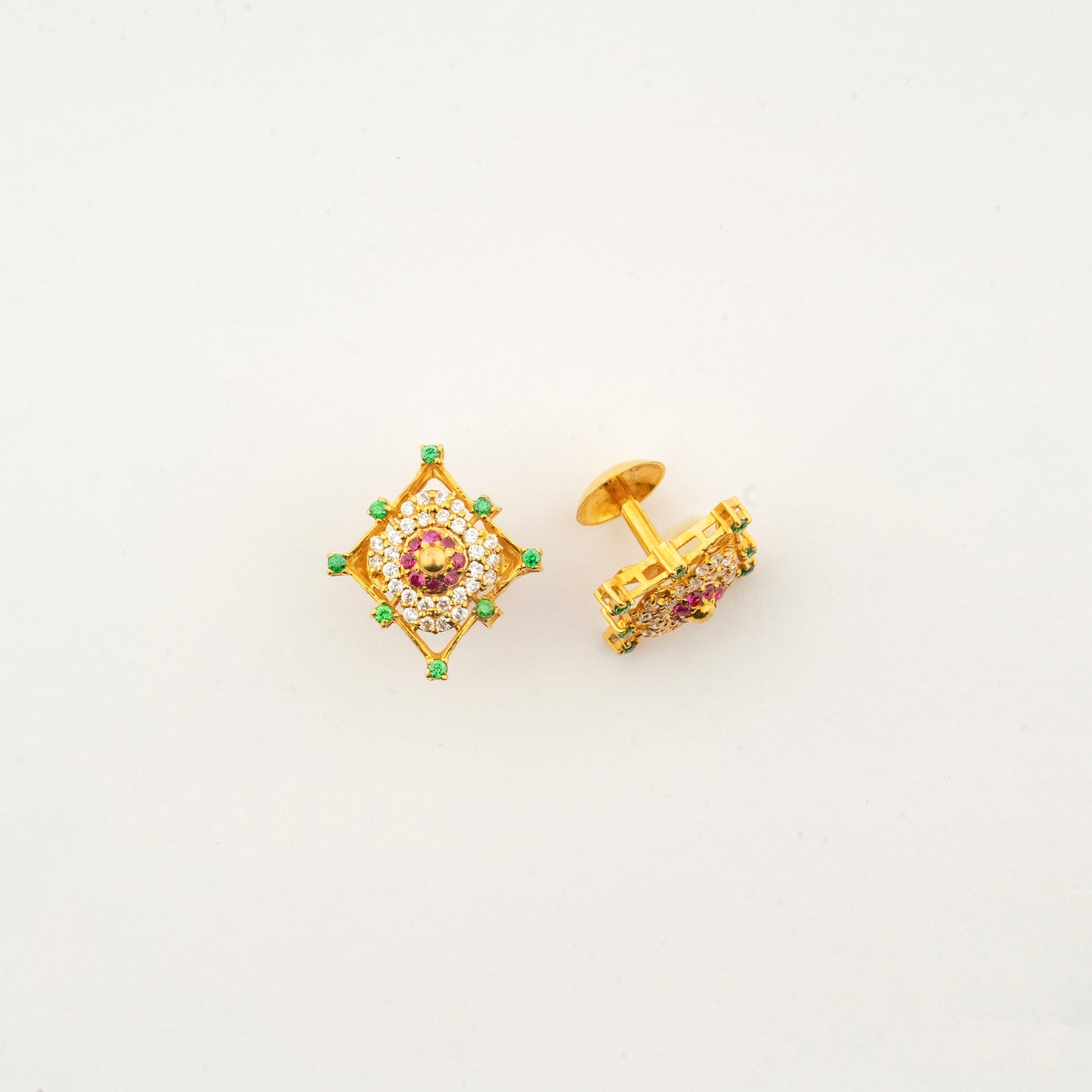 Close-up of Sculptyx Masrique Rosan 22K gold floral stud earrings showcasing intricate handcrafted gemstone detailing.