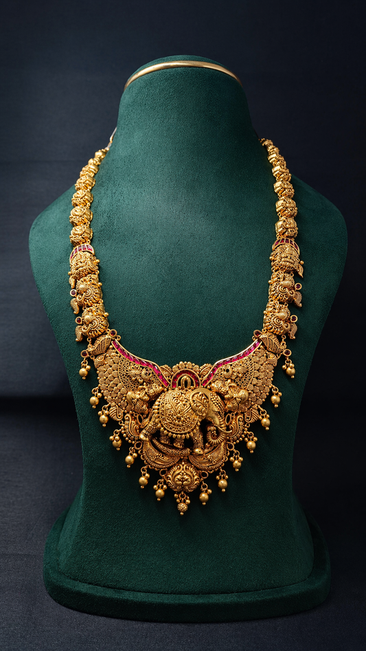 Handcrafted 22K Gold Gaja Lakshmi Temple Haram necklace with elephant centerpiece, Nakshi detailing, ruby accents, and traditional South Indian bridal design.