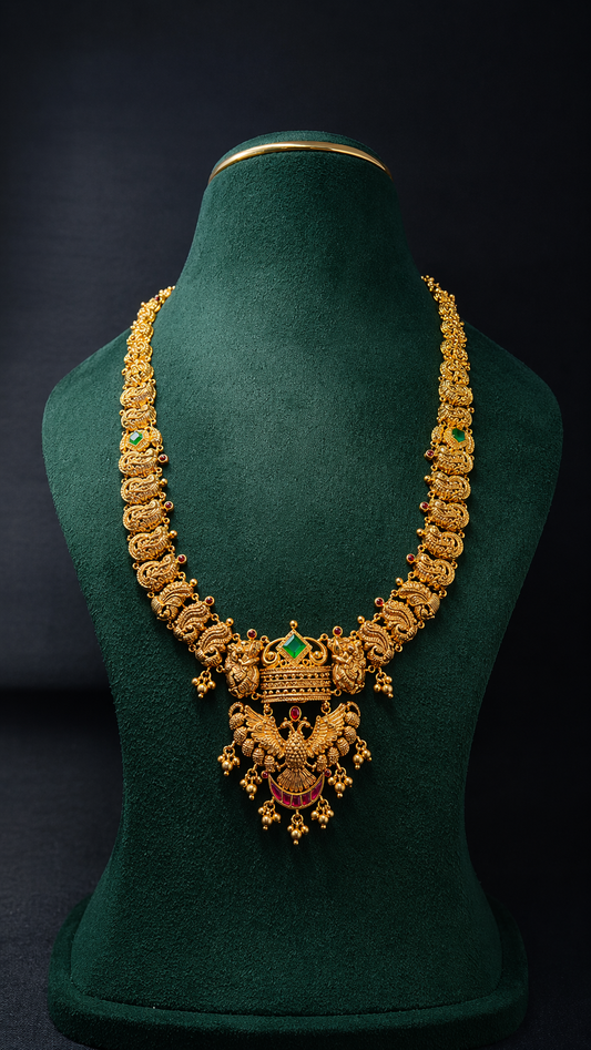 Handcrafted 22K Gold Gandaberunda Temple Haram necklace with green stone centerpiece, Nakshi detailing, and traditional South Indian craftsmanship.