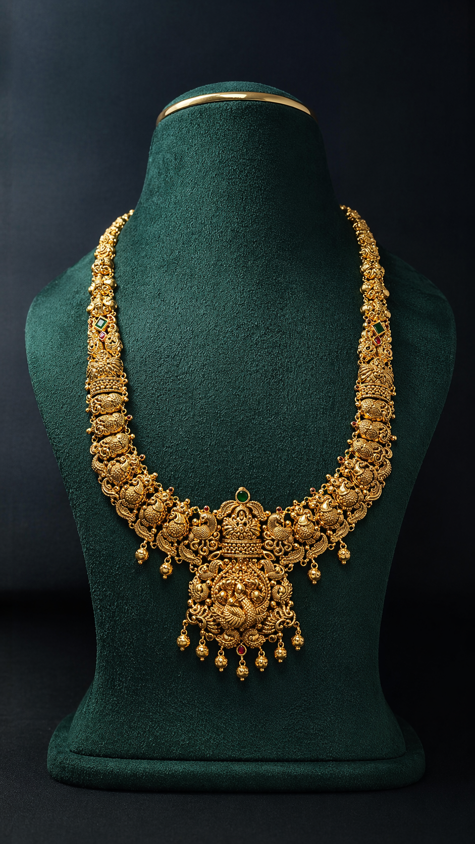 Handcrafted 22K Gold Lakshmi Peacock Temple Haram necklace with Nakshi detailing, green stone accent, and traditional South Indian bridal design.