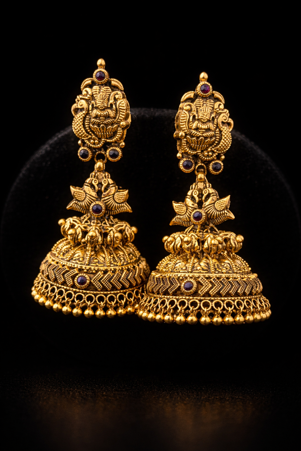 22K Gold Lakshmi Peacock Temple Jhumka earrings with ruby stone accents and antique finish.