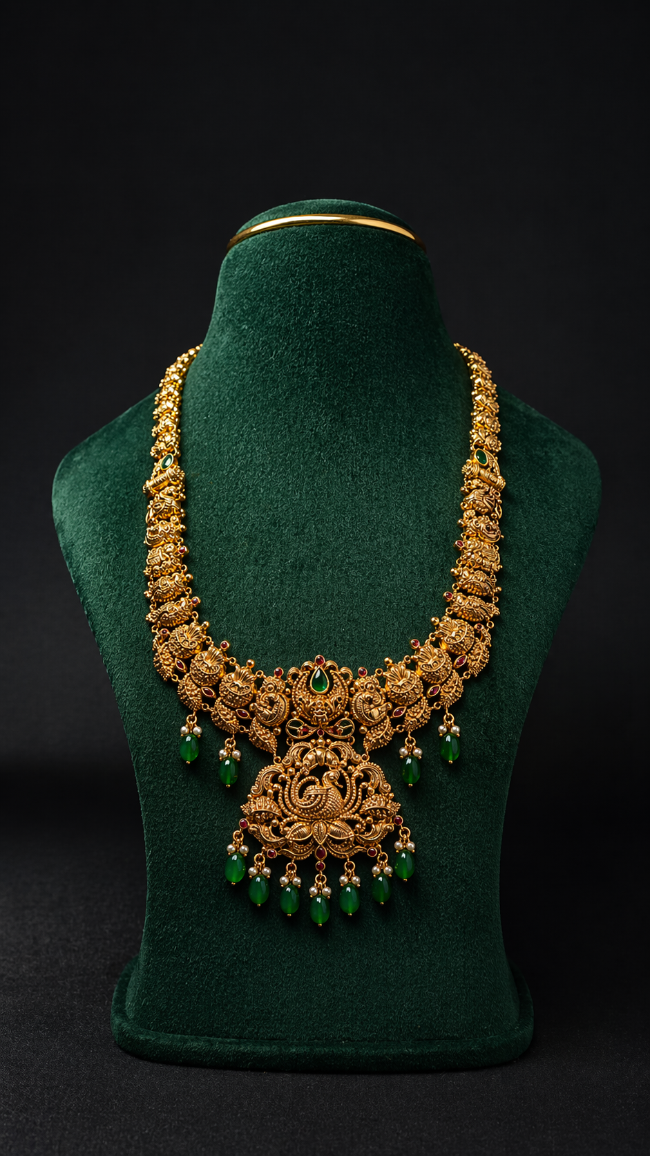 Handcrafted 22K Gold Makara Temple Haram necklace with Nakshi detailing, emerald green bead drops, and traditional South Indian bridal craftsmanship.