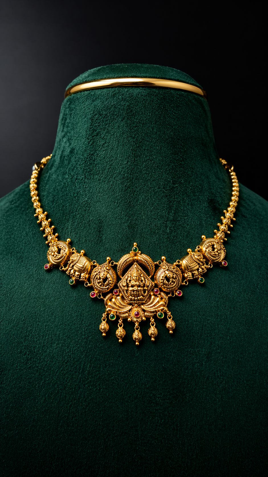 Lightweight 22K gold Lakshmi peacock short necklace with elephant motifs and ruby, emerald-inspired accents in a traditional South Indian jewellery design.