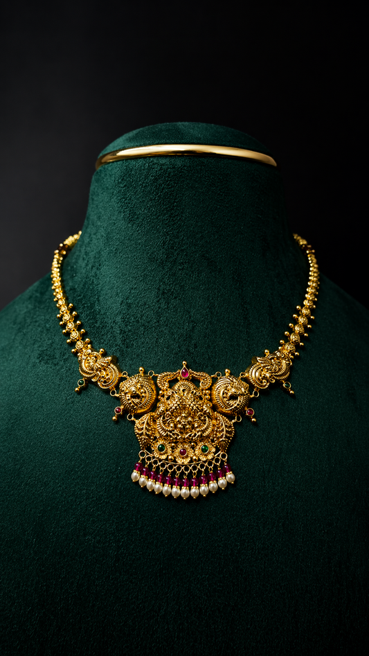Lightweight 22K gold Lakshmi short necklace with ruby, emerald-inspired stones and pearl drops in a traditional South Indian design.