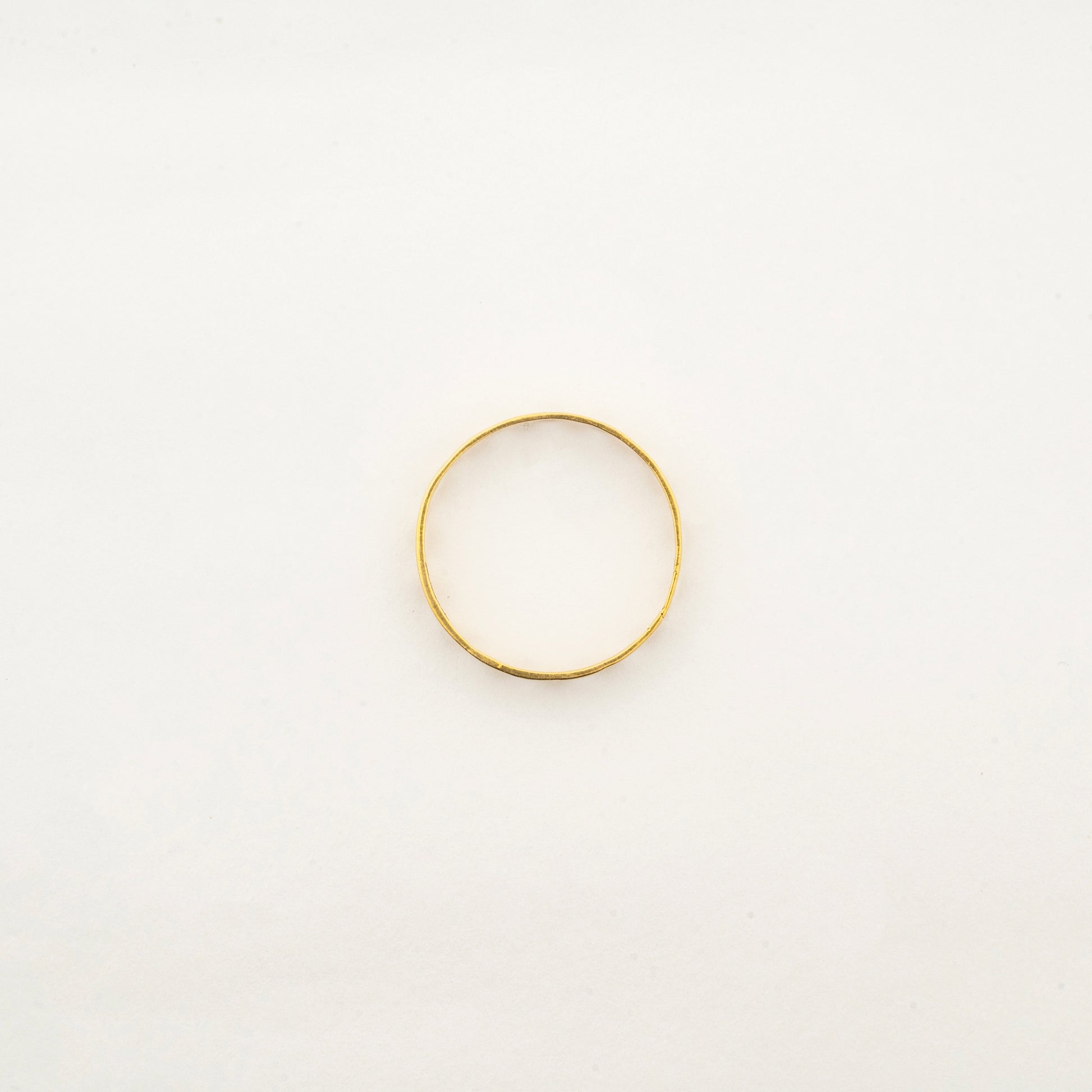 Top view of the handcrafted Sculptyx Caelure 18K gold ring showcasing its refined minimalist silhouette.