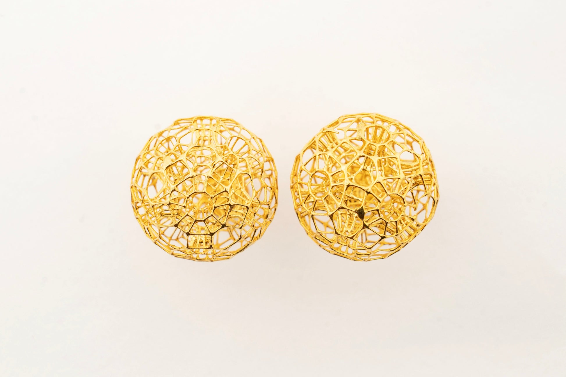 Celestara Orbs 18K gold stud earrings featuring a textured spherical design crafted by Sculptyx.