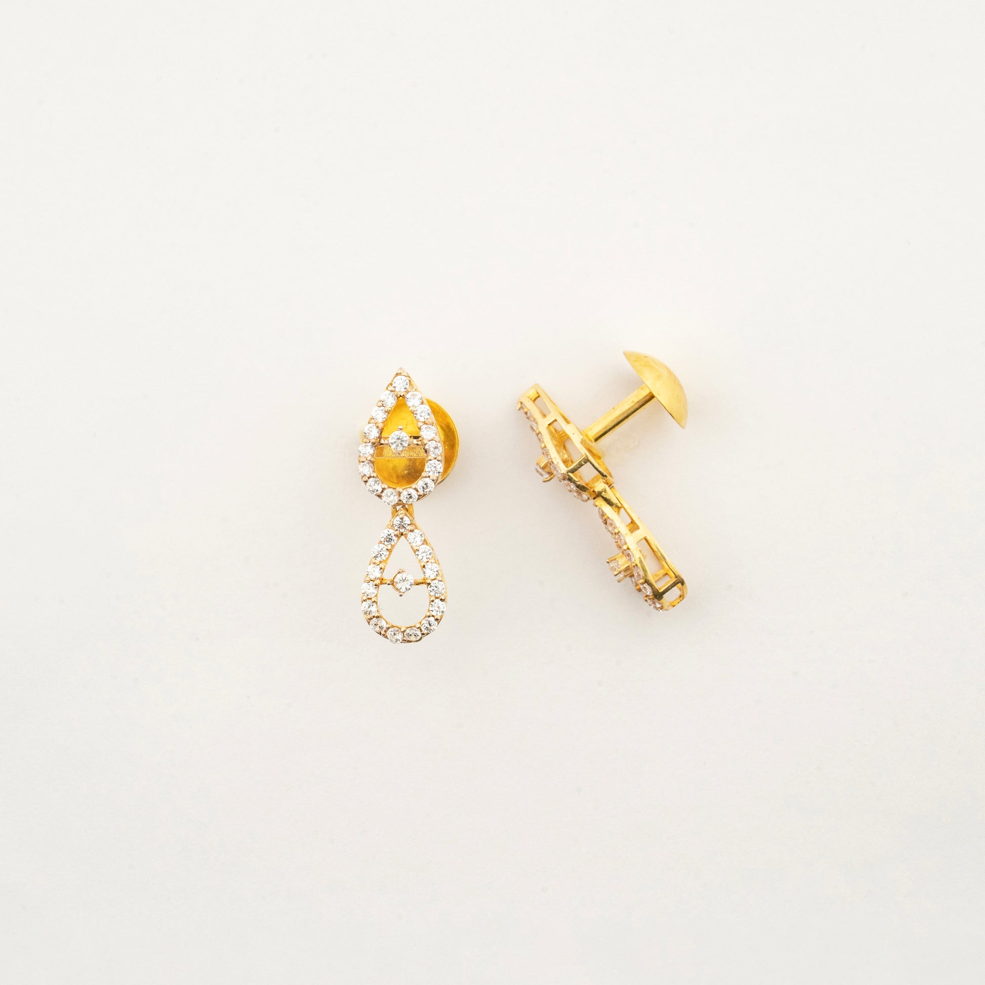Side profile of Sculptyx Celestial Drops 18K gold crystal drop earrings with delicate teardrop design.