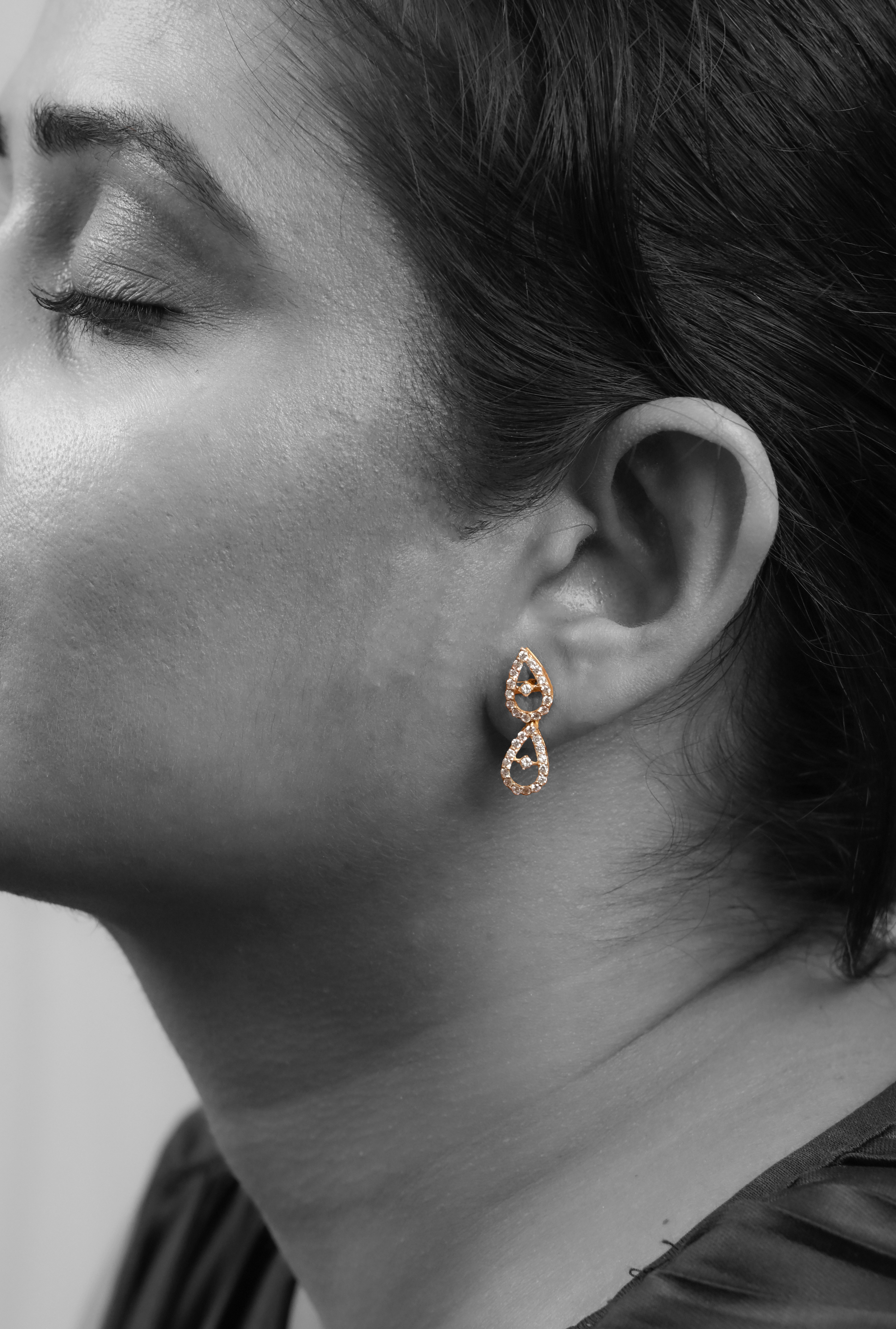 Model wearing Sculptyx Celestial Drops handcrafted 18K gold crystal drop earrings.