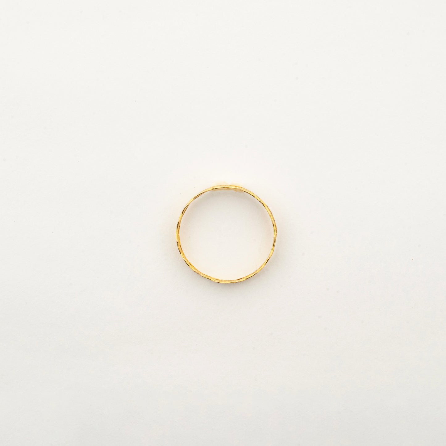 Top view of the handcrafted Sculptyx Ethereal Lace 18K gold ring showcasing its refined minimalist silhouette and textured finish.