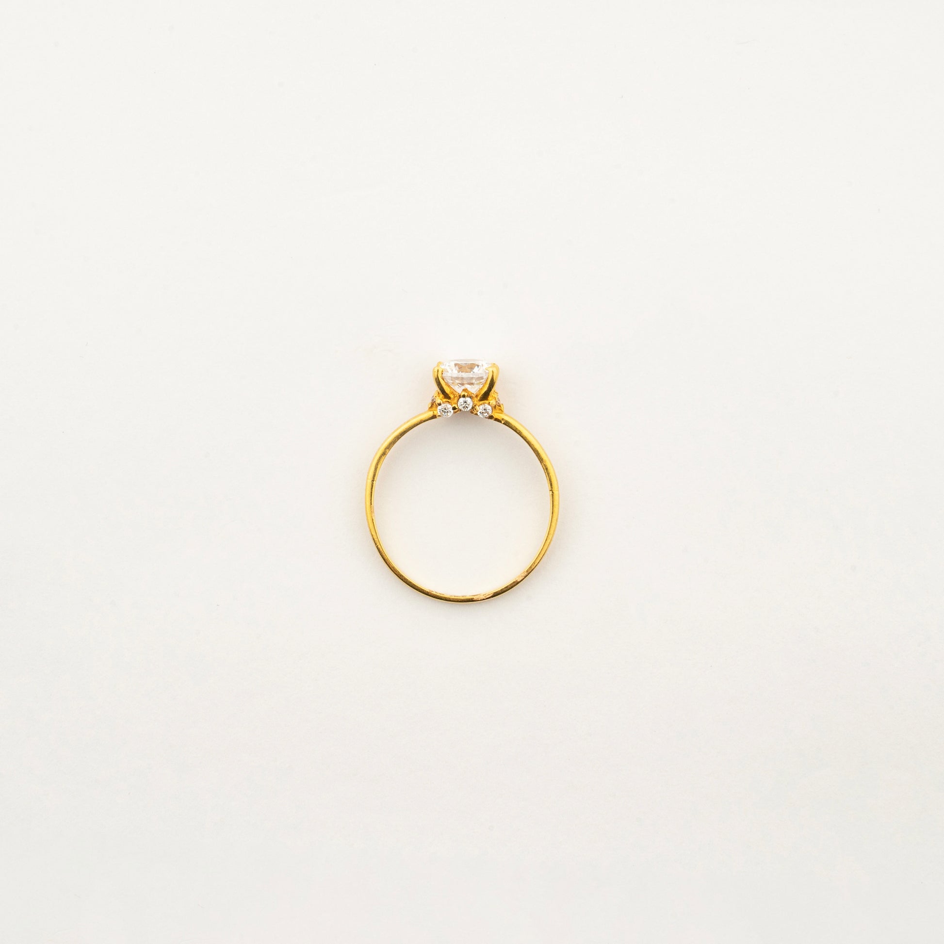 Top view of Sculptyx Glacier Crest 22K gold solitaire crystal ring showcasing its elegant handcrafted design.