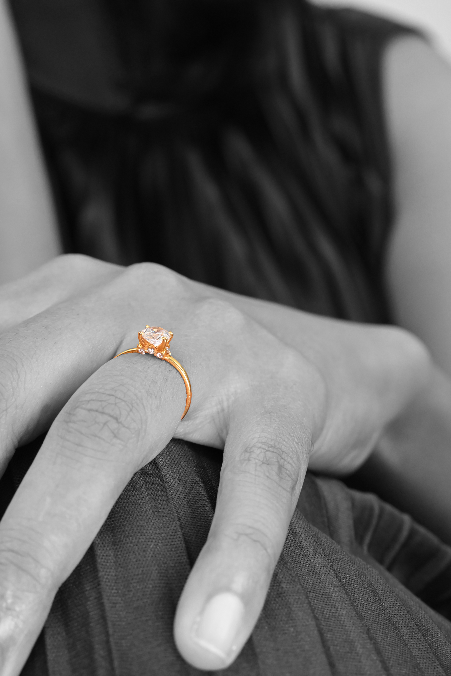 Close-up of Sculptyx Glacier Crest 22K gold solitaire ring on hand.