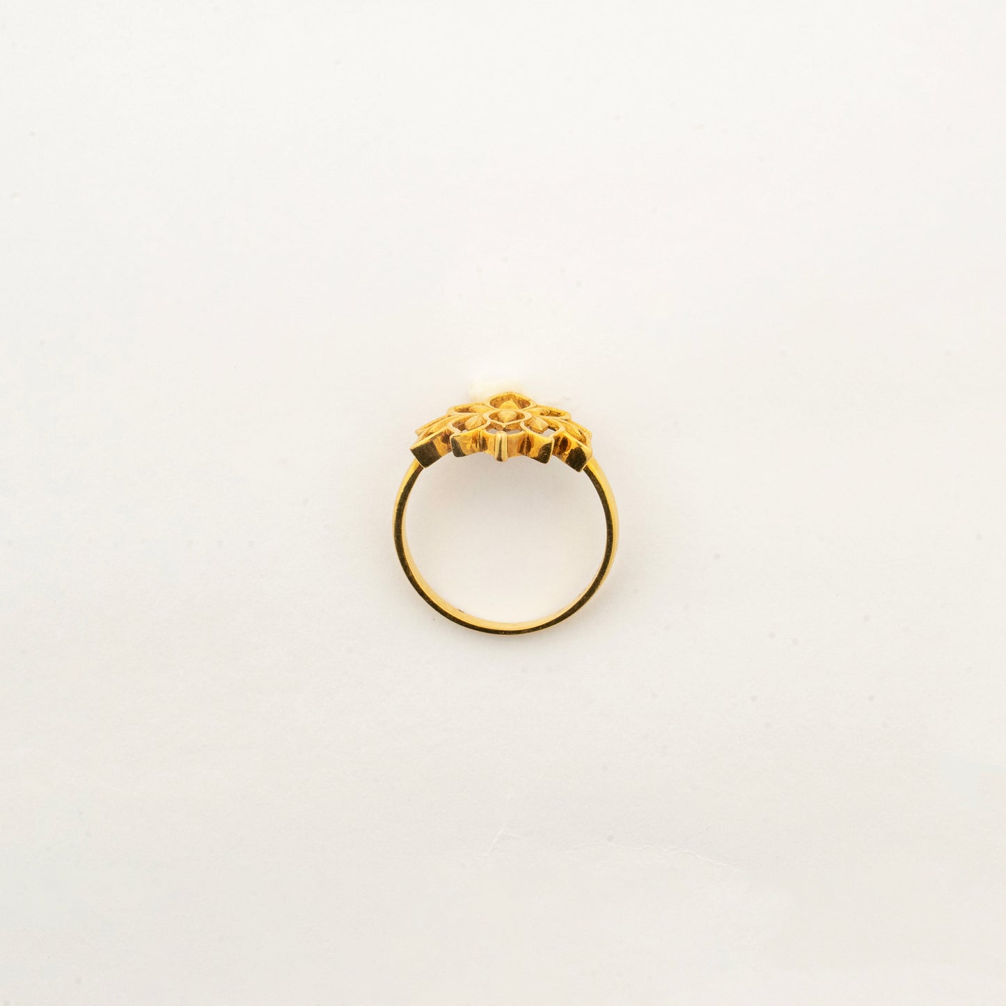Angled view of the Sculptyx Golden Lotus 22K gold lotus ring showcasing its sculpted floral silhouette.