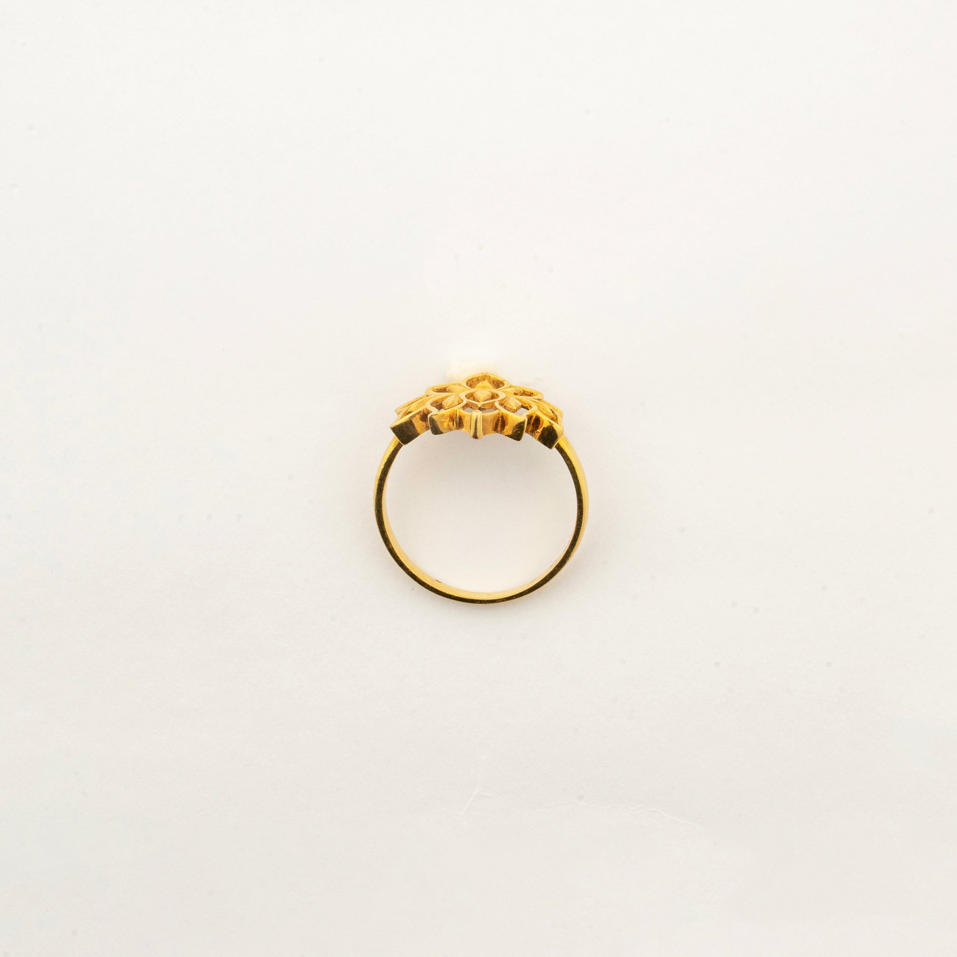 Angled view of the Sculptyx Golden Lotus 22K gold lotus ring showcasing its sculpted floral silhouette.
