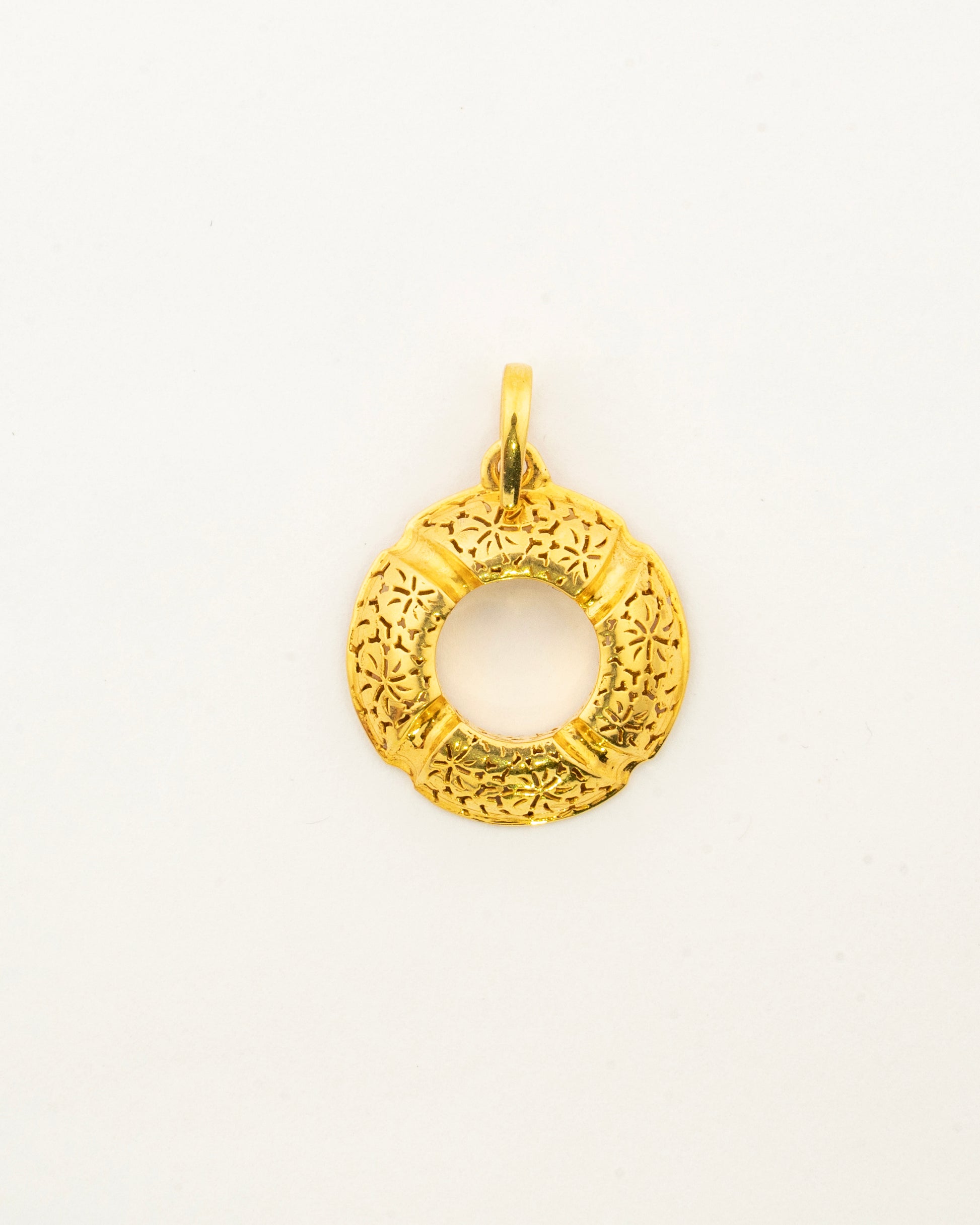 Front view of the handcrafted Sculptyx Golden Meridian 18K gold pendant showcasing its elegant circular silhouette.