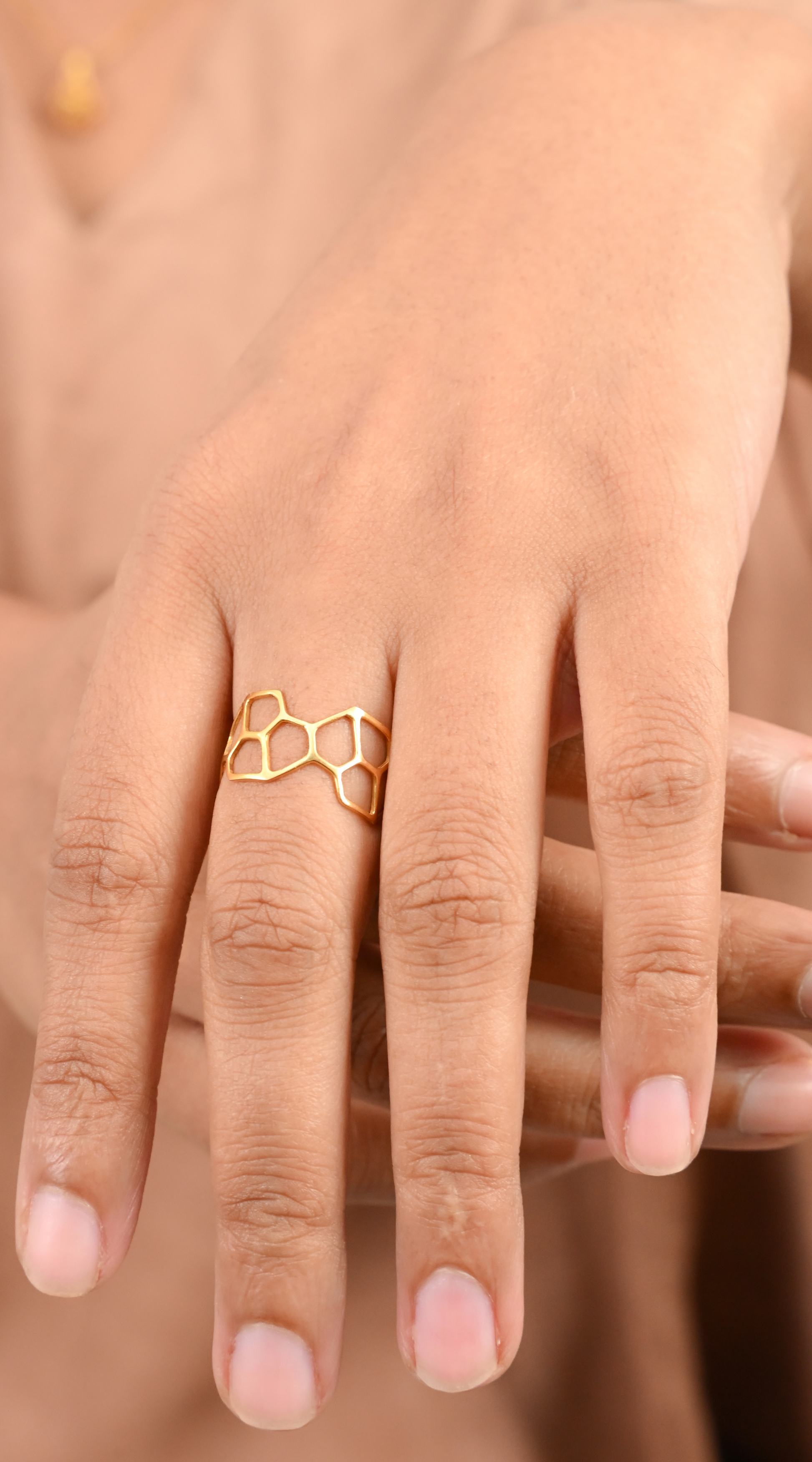 Model wearing the Sculptyx Hivemind handcrafted 18K gold geometric statement ring.