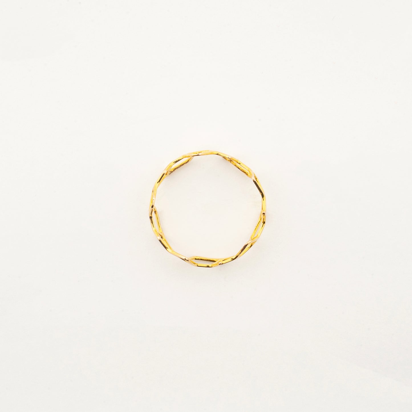 Top view of Sculptyx Hivemind 18K gold geometric statement ring showcasing its intricate openwork design.