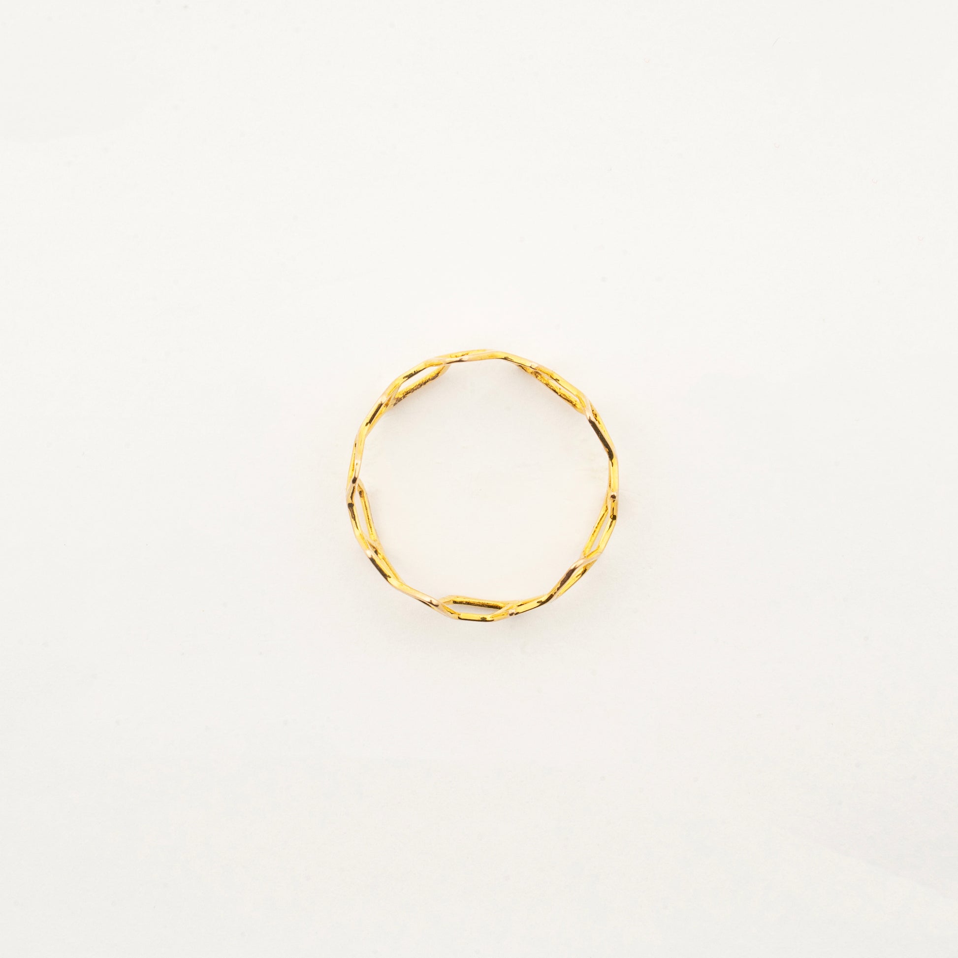 Top view of Sculptyx Hivemind 18K gold geometric statement ring showcasing its intricate openwork design.