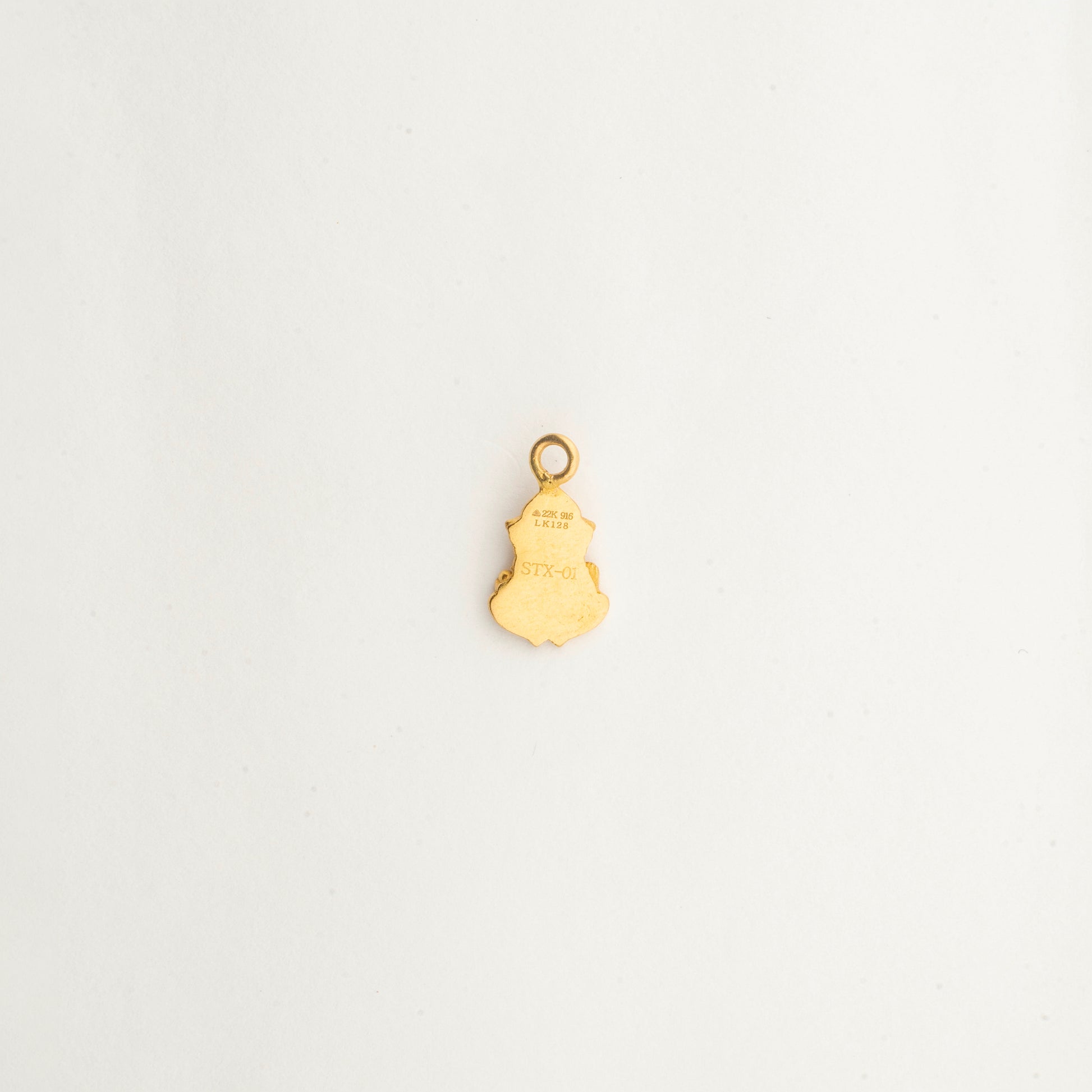 Close-up of the handcrafted 22K gold Lord Ganesha pendant by Sculptyx with intricate sacred detailing and polished finish.