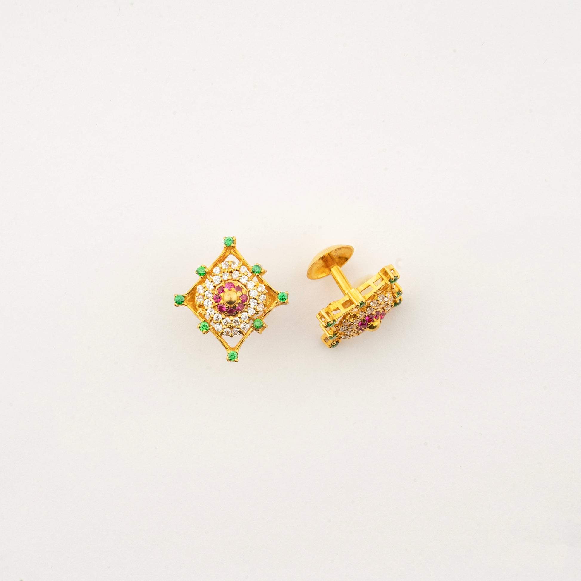Close-up of Sculptyx Masrique Rosan 22K gold floral stud earrings showcasing intricate handcrafted gemstone detailing.