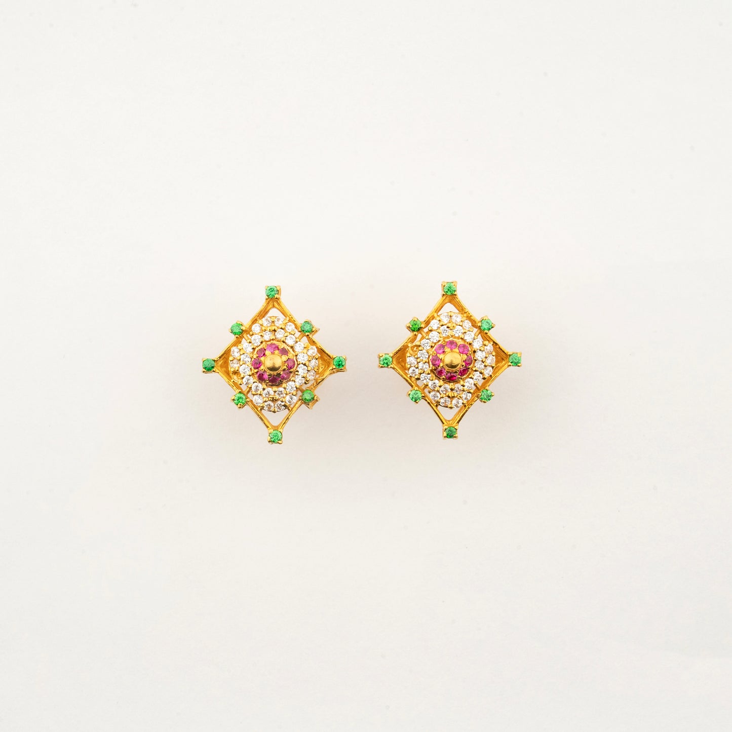 Sculptyx Masrique Rosan handcrafted 22K gold floral stud earrings featuring vibrant red and green gemstone accents.
