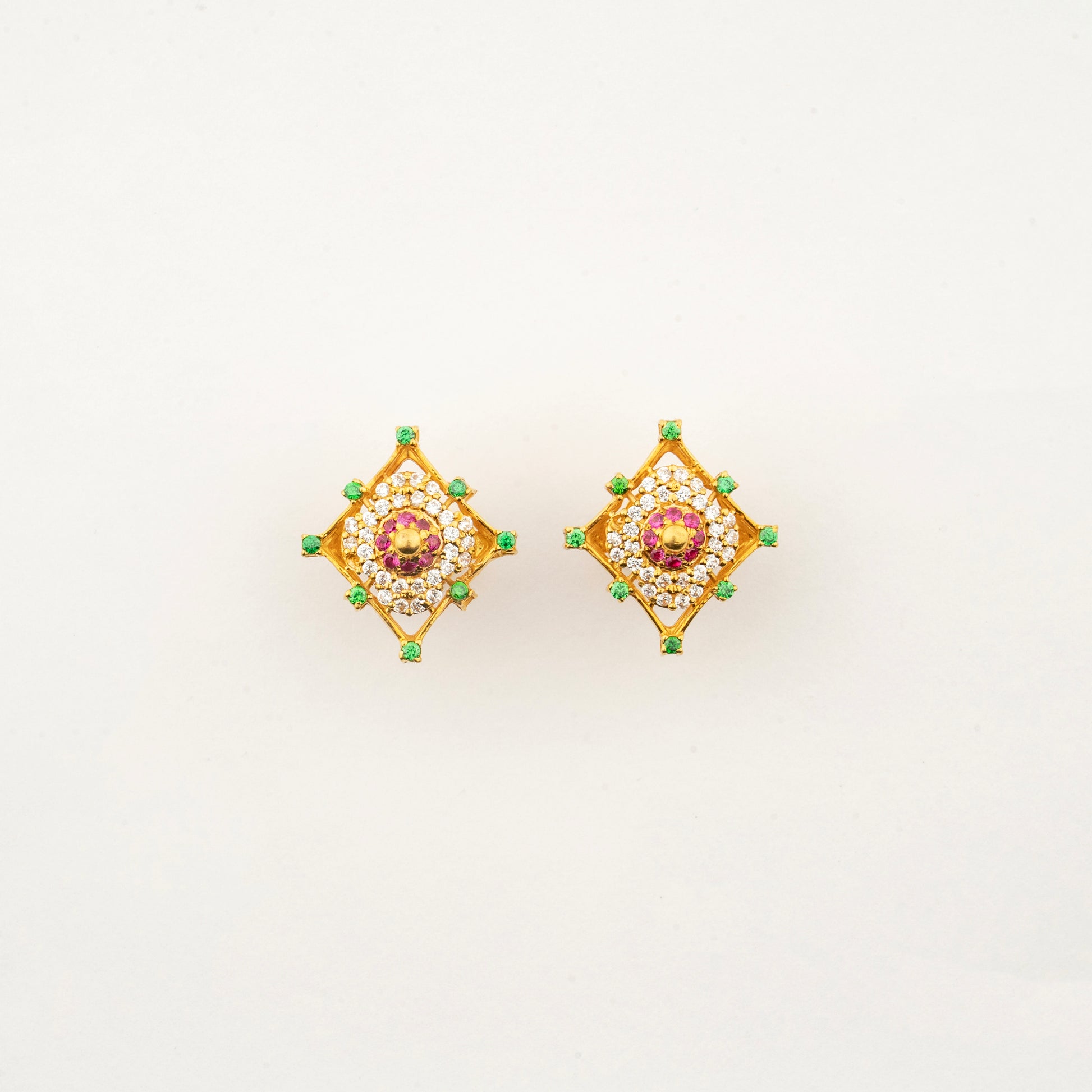 Sculptyx Masrique Rosan handcrafted 22K gold floral stud earrings featuring vibrant red and green gemstone accents.