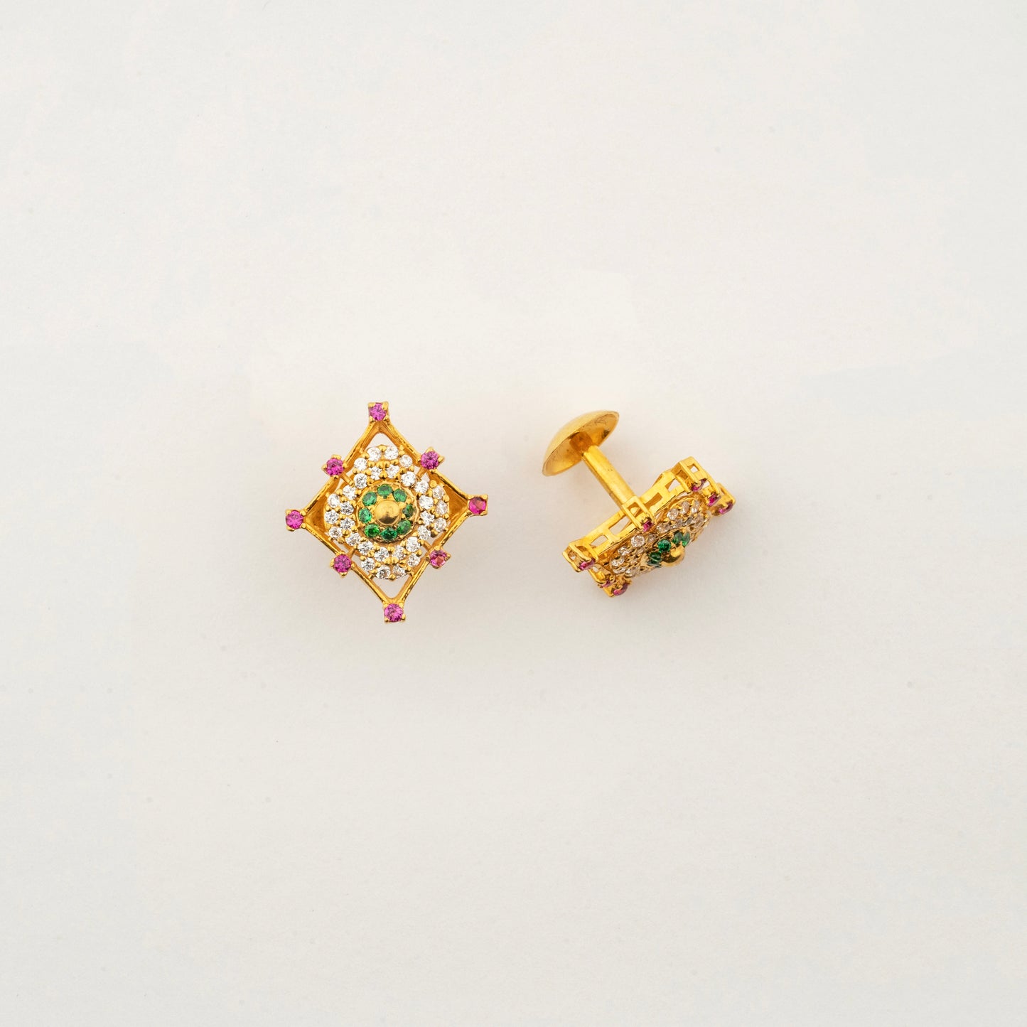 Close-up of Sculptyx Masrique Verda 22K gold floral stud earrings showcasing intricate handcrafted gemstone detailing.