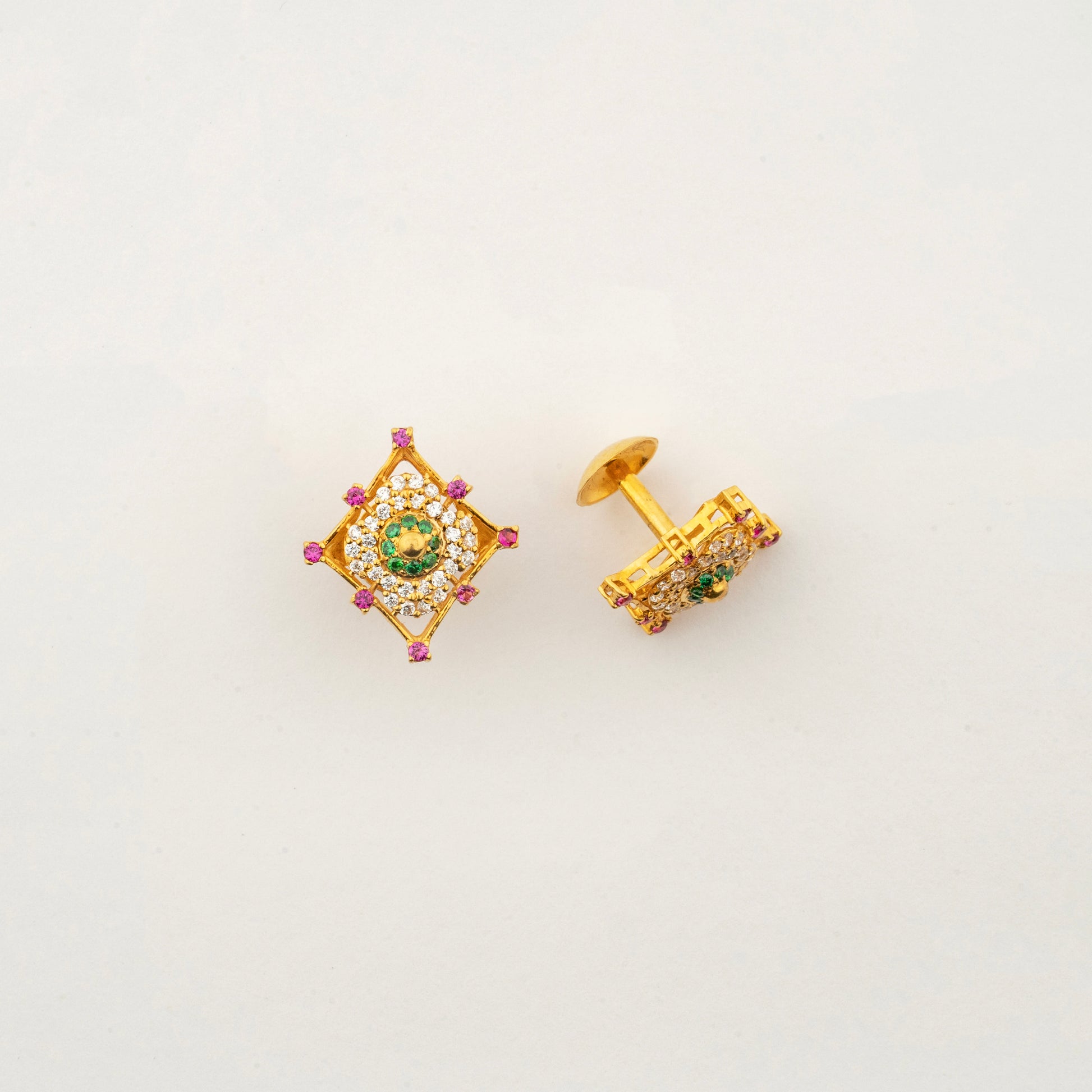 Close-up of Sculptyx Masrique Verda 22K gold floral stud earrings showcasing intricate handcrafted gemstone detailing.