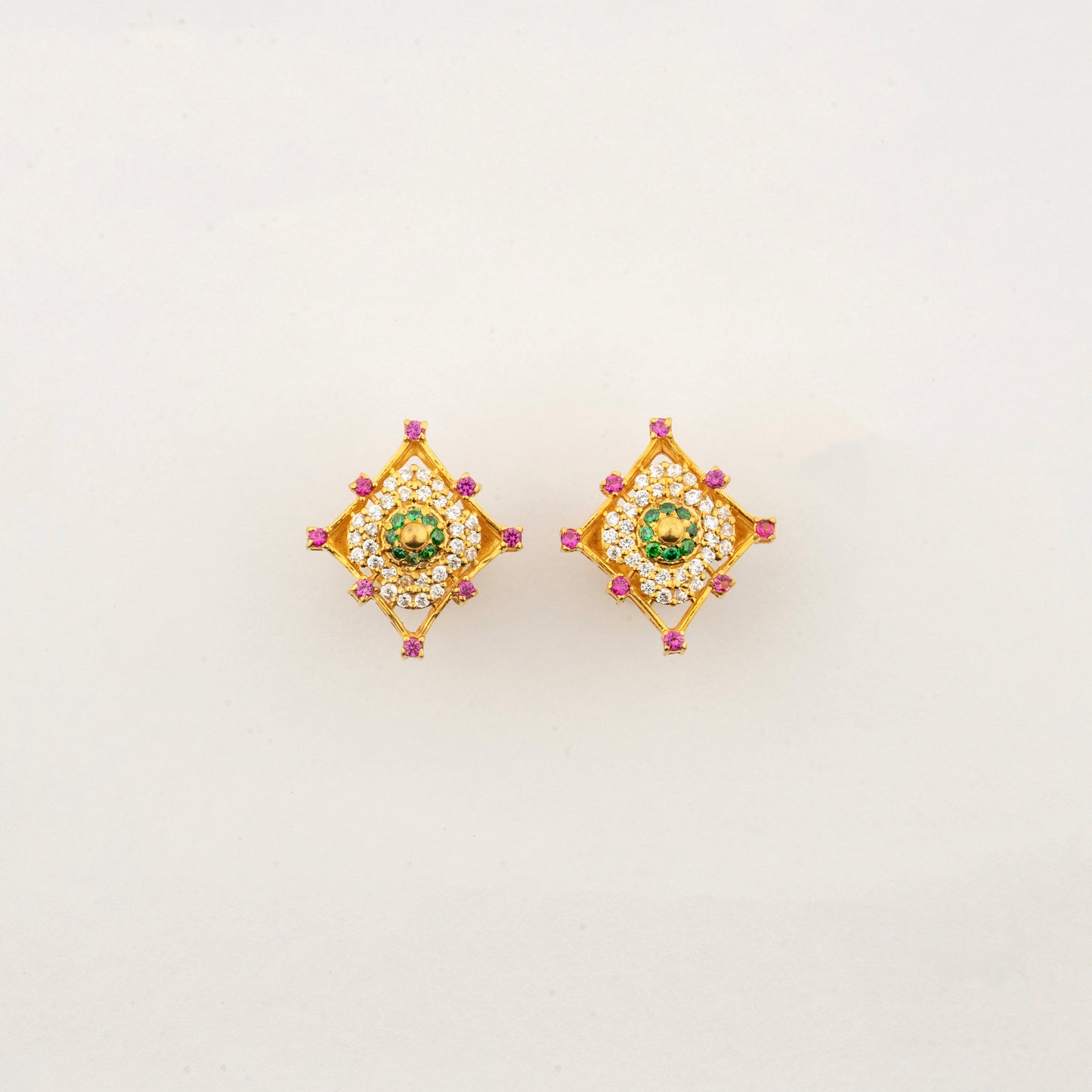 Sculptyx Masrique Verda handcrafted 22K gold floral stud earrings featuring elegant green and red gemstone accents.