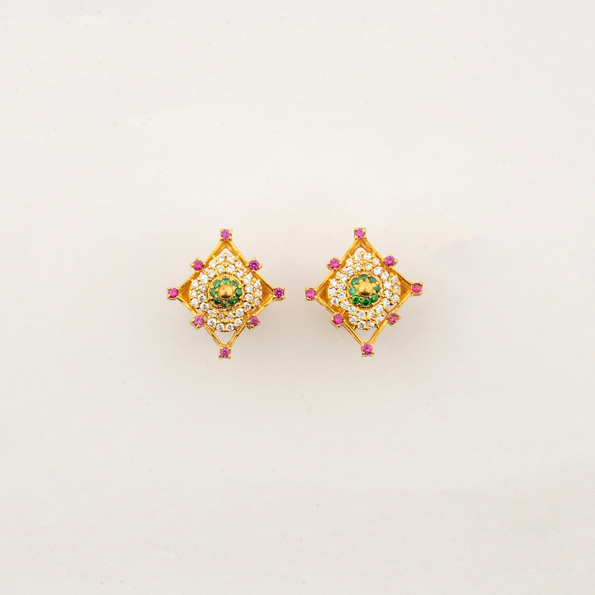 Sculptyx Masrique Verda handcrafted 22K gold floral stud earrings featuring elegant green and red gemstone accents.