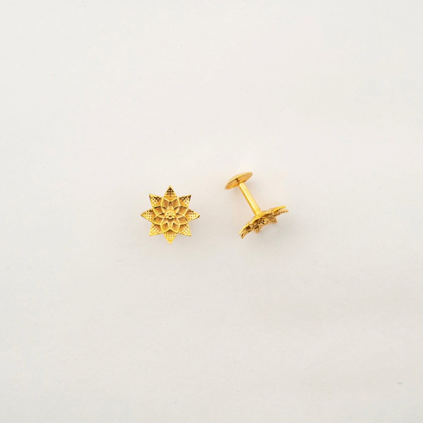 Close-up of Sculptyx Petralis Array 18K gold botanical stud earrings showcasing intricate handcrafted petal details.