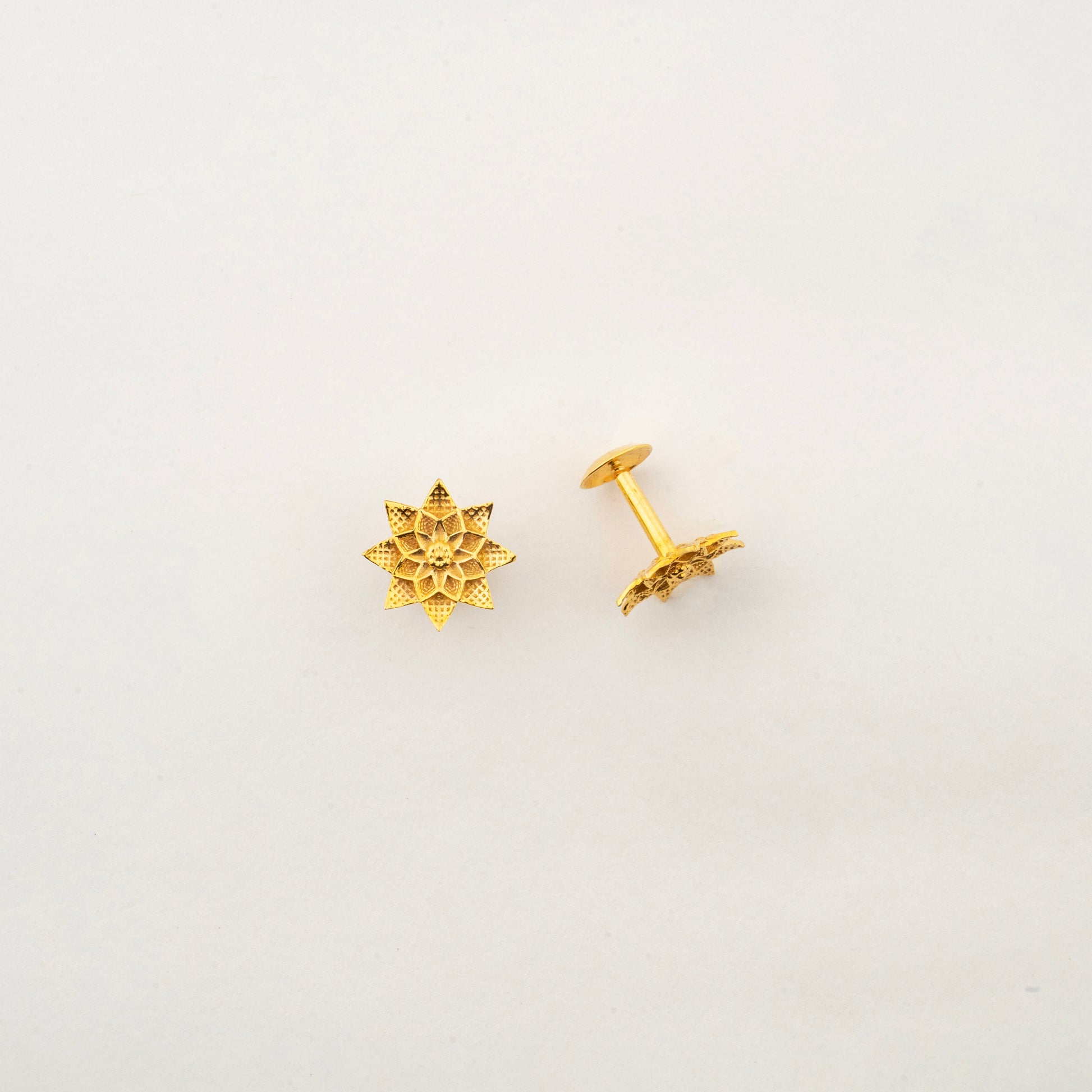Close-up of Sculptyx Petralis Array 18K gold botanical stud earrings showcasing intricate handcrafted petal details.