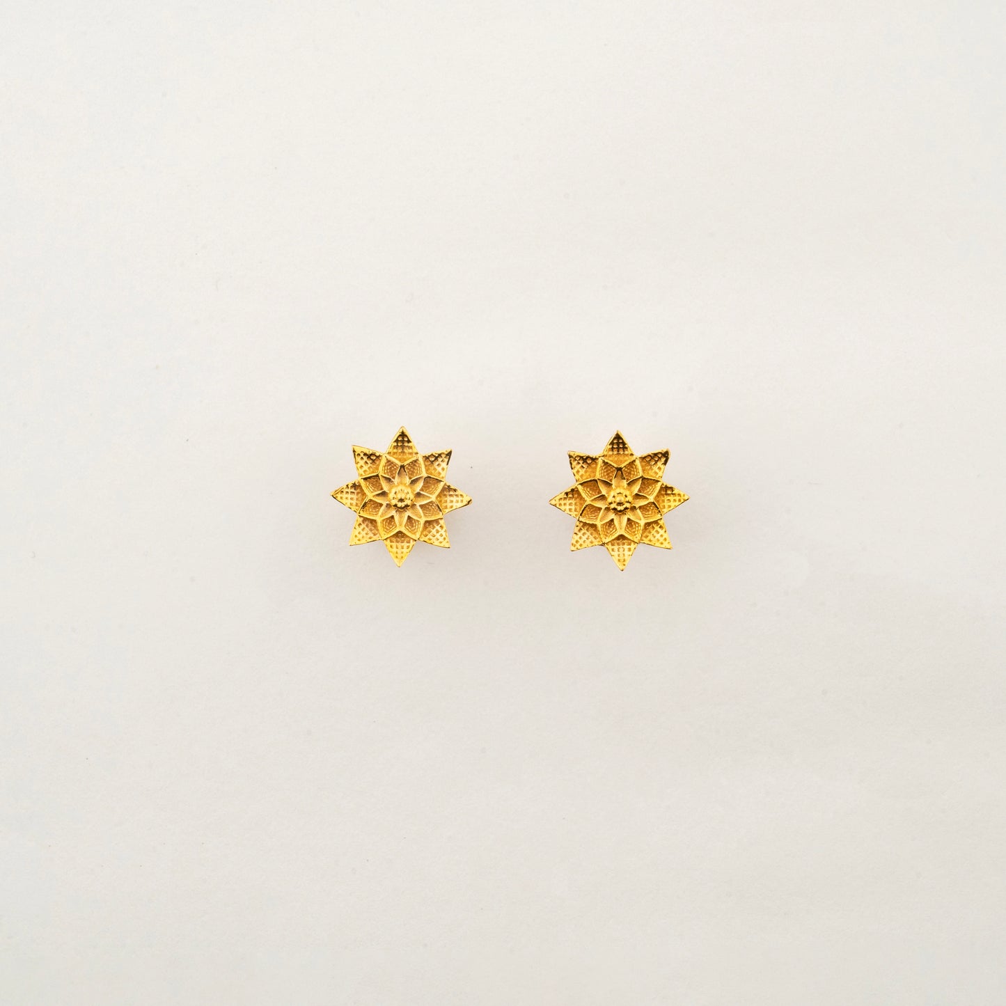 Sculptyx Petralis Array handcrafted 18K gold botanical stud earrings featuring layered petal-inspired detailing and lightweight elegance.