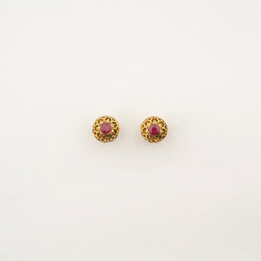Sculptyx Ravikara handcrafted 18K gold ruby stud earrings featuring a textured antique-inspired gold setting with vibrant ruby gemstones.