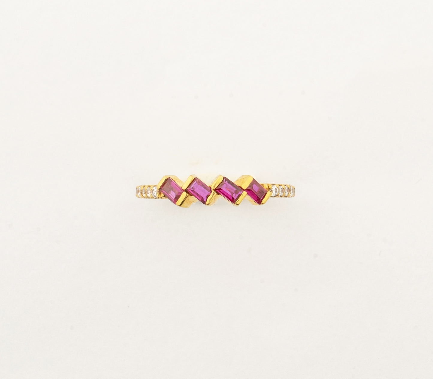 Sculptyx Rubra Cascade handcrafted 22K gold ruby ring featuring a modern geometric row of vibrant ruby gemstones.