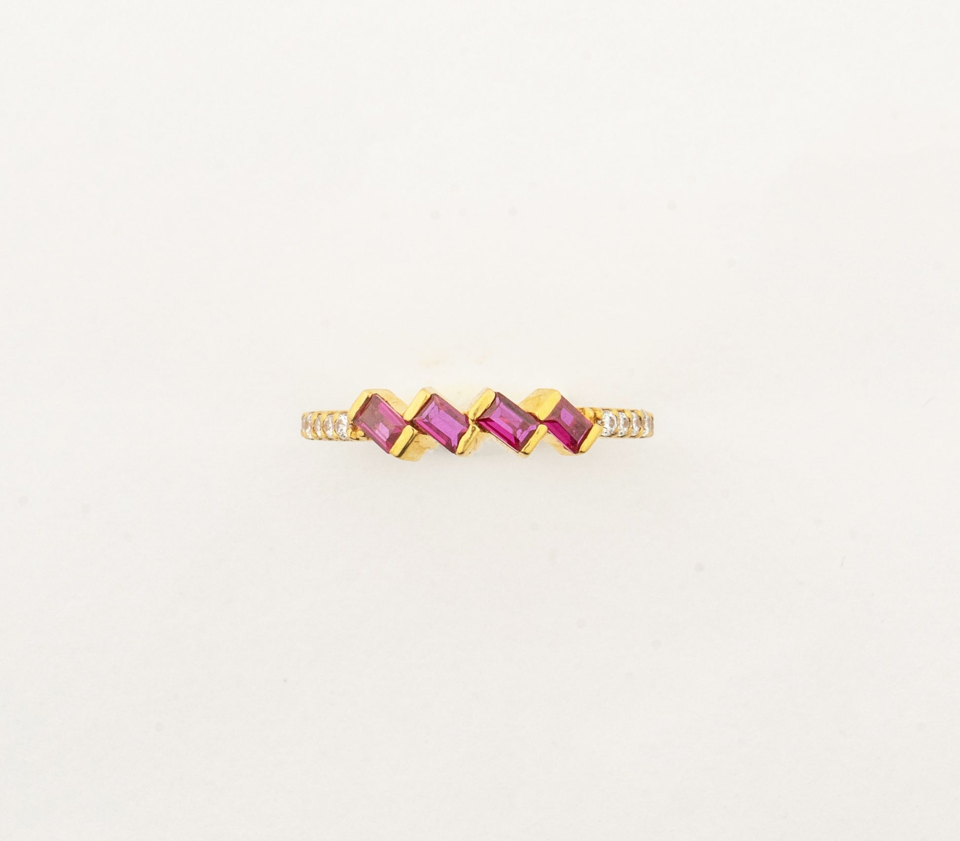 Sculptyx Rubra Cascade handcrafted 22K gold ruby ring featuring a modern geometric row of vibrant ruby gemstones.