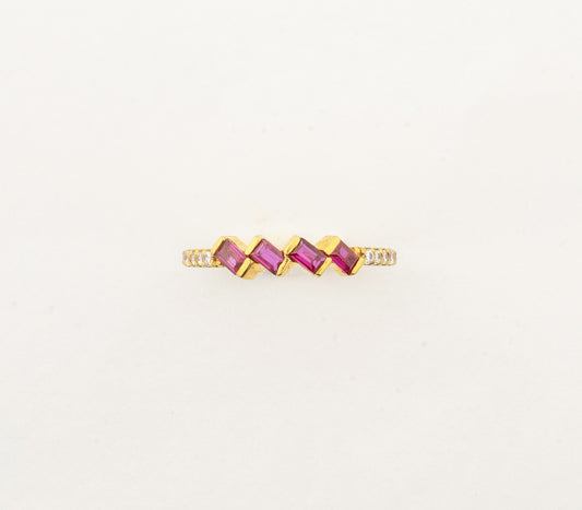 Sculptyx Rubra Cascade handcrafted 22K gold ruby ring featuring a modern geometric row of vibrant ruby gemstones.