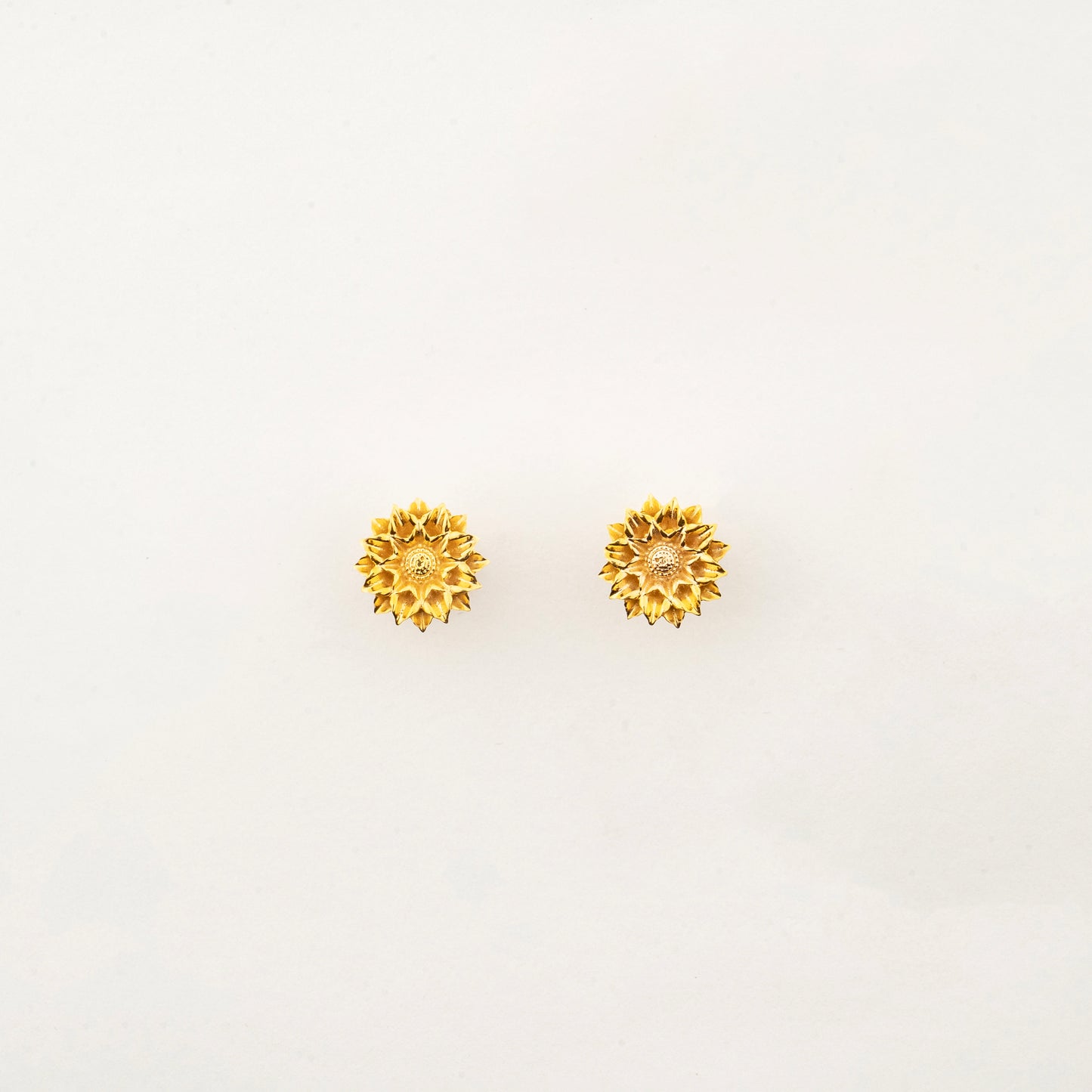 Sculptyx Solaris Crest handcrafted 18K gold stud earrings featuring a radiant sun-inspired floral design for everyday luxury.