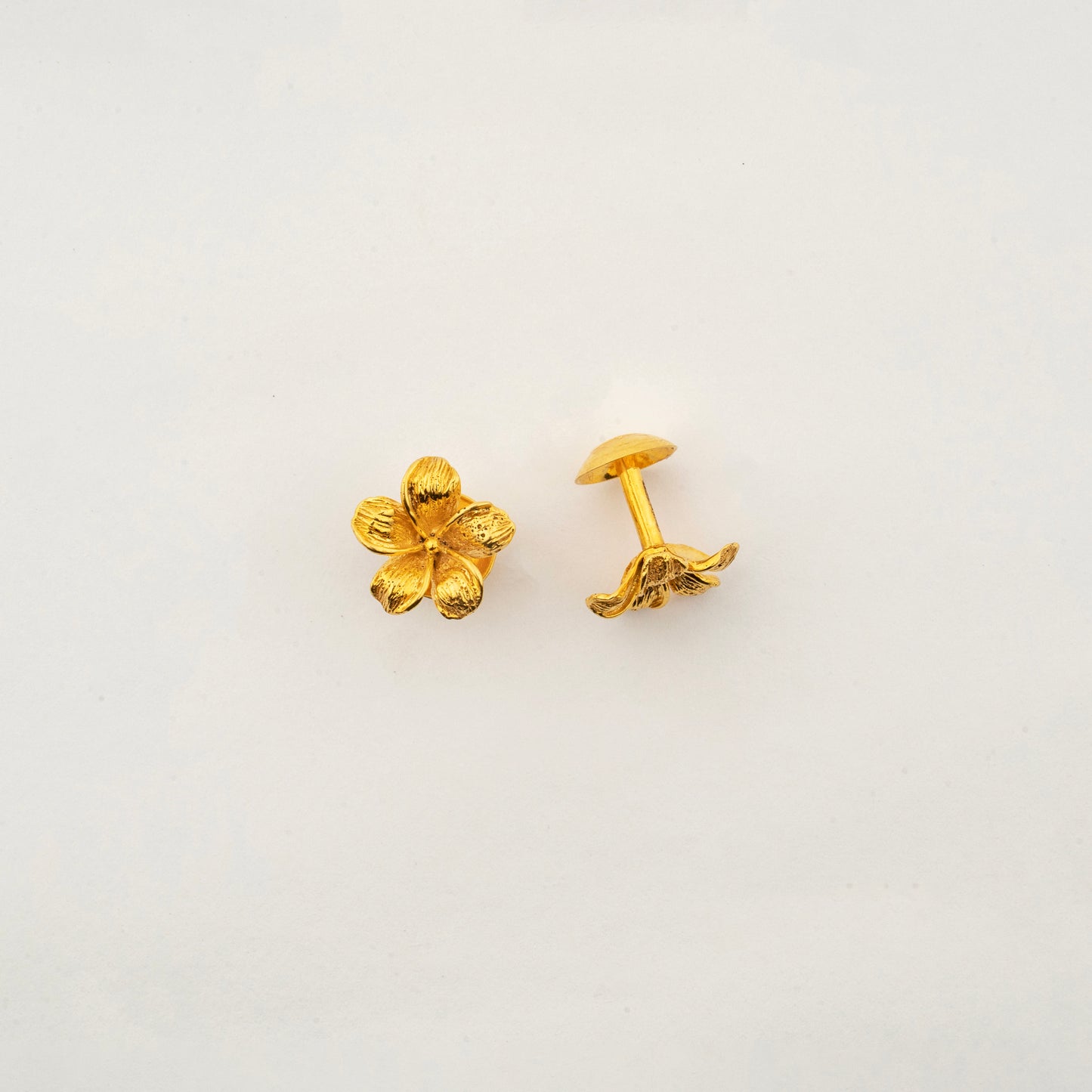 Close-up of Sculptyx The Blooming Hour 18K gold floral stud earrings highlighting handcrafted petal detailing.