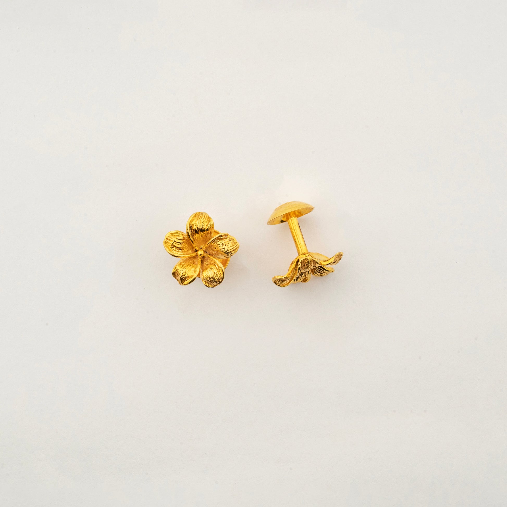 Close-up of Sculptyx The Blooming Hour 18K gold floral stud earrings highlighting handcrafted petal detailing.
