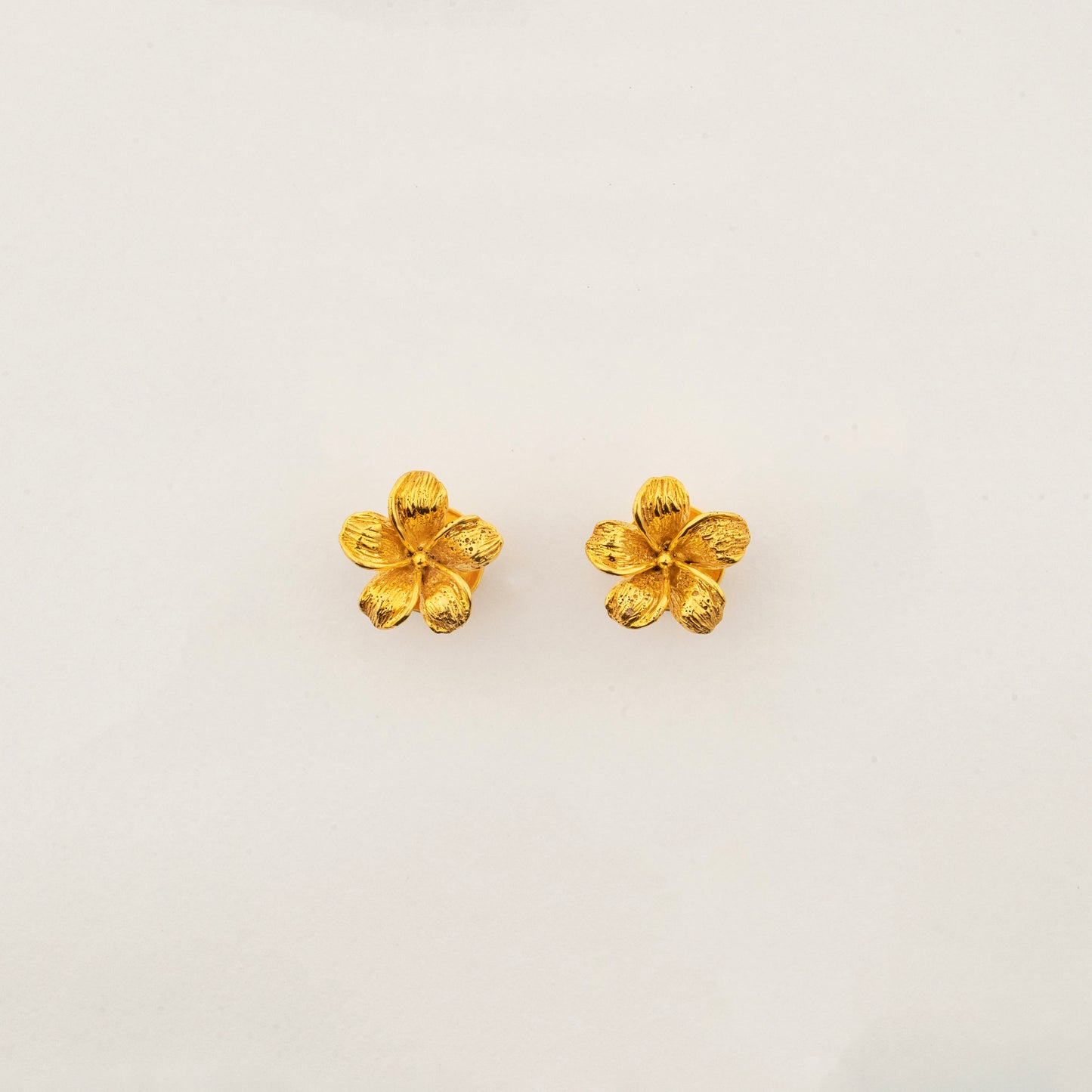 Sculptyx The Blooming Hour handcrafted 18K gold floral stud earrings inspired by a blooming five-petal flower.