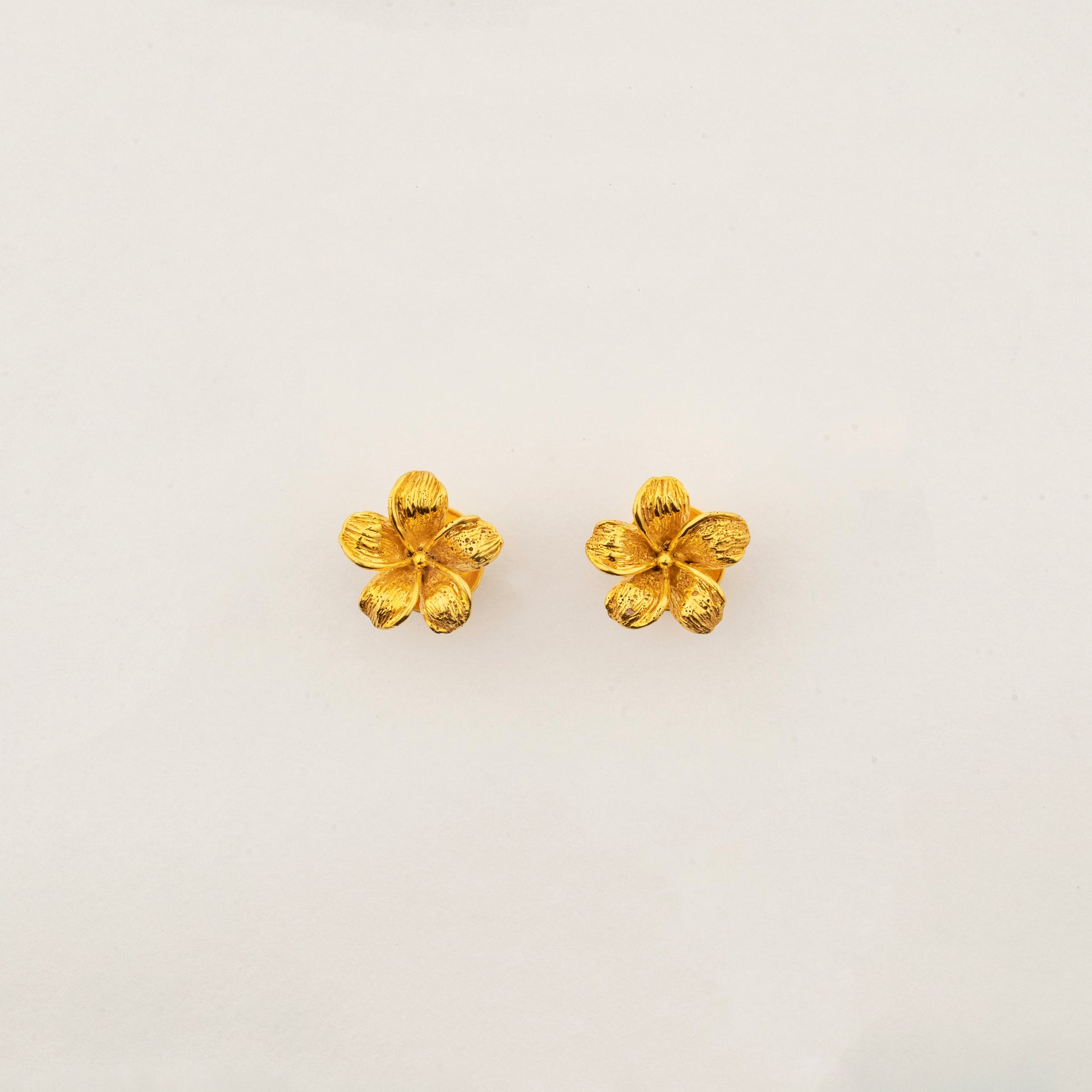 Sculptyx The Blooming Hour handcrafted 18K gold floral stud earrings inspired by a blooming five-petal flower.