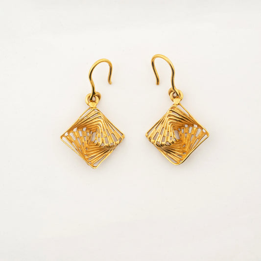 Sculptyx The Golden Parallax handcrafted 18K gold geometric drop earrings featuring an intricate openwork diamond design.