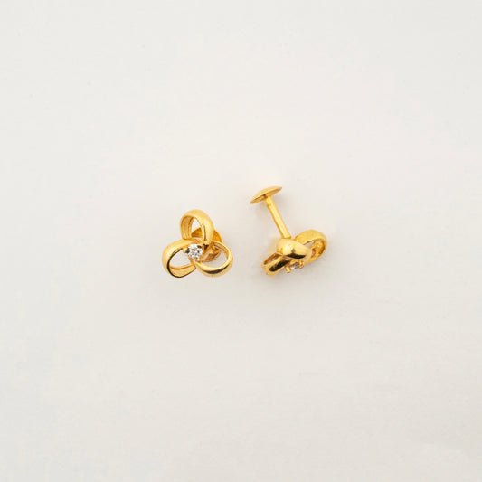 Sculptyx Tressara handcrafted 18K gold natural diamond stud earrings featuring elegant interlocking curves with a brilliant natural diamond centerpiece.