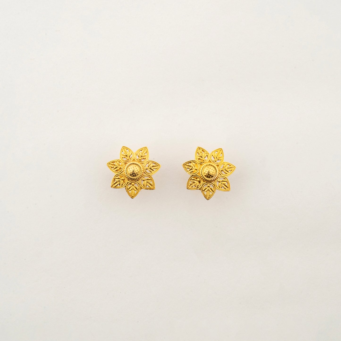 Close-up of Sculptyx Verdelis Six 18K gold botanical leaf stud earrings showcasing intricate handcrafted detailing.