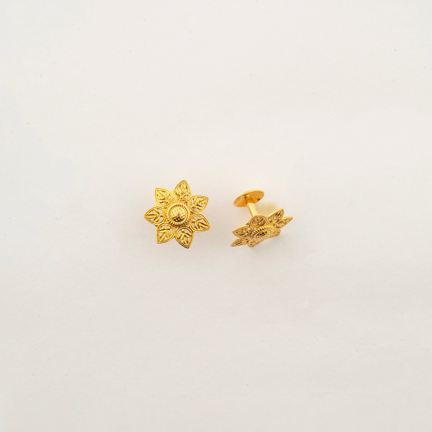 Sculptyx Verdelis Six handcrafted 18K gold botanical leaf stud earrings featuring six sculpted petals inspired by natural foliage.